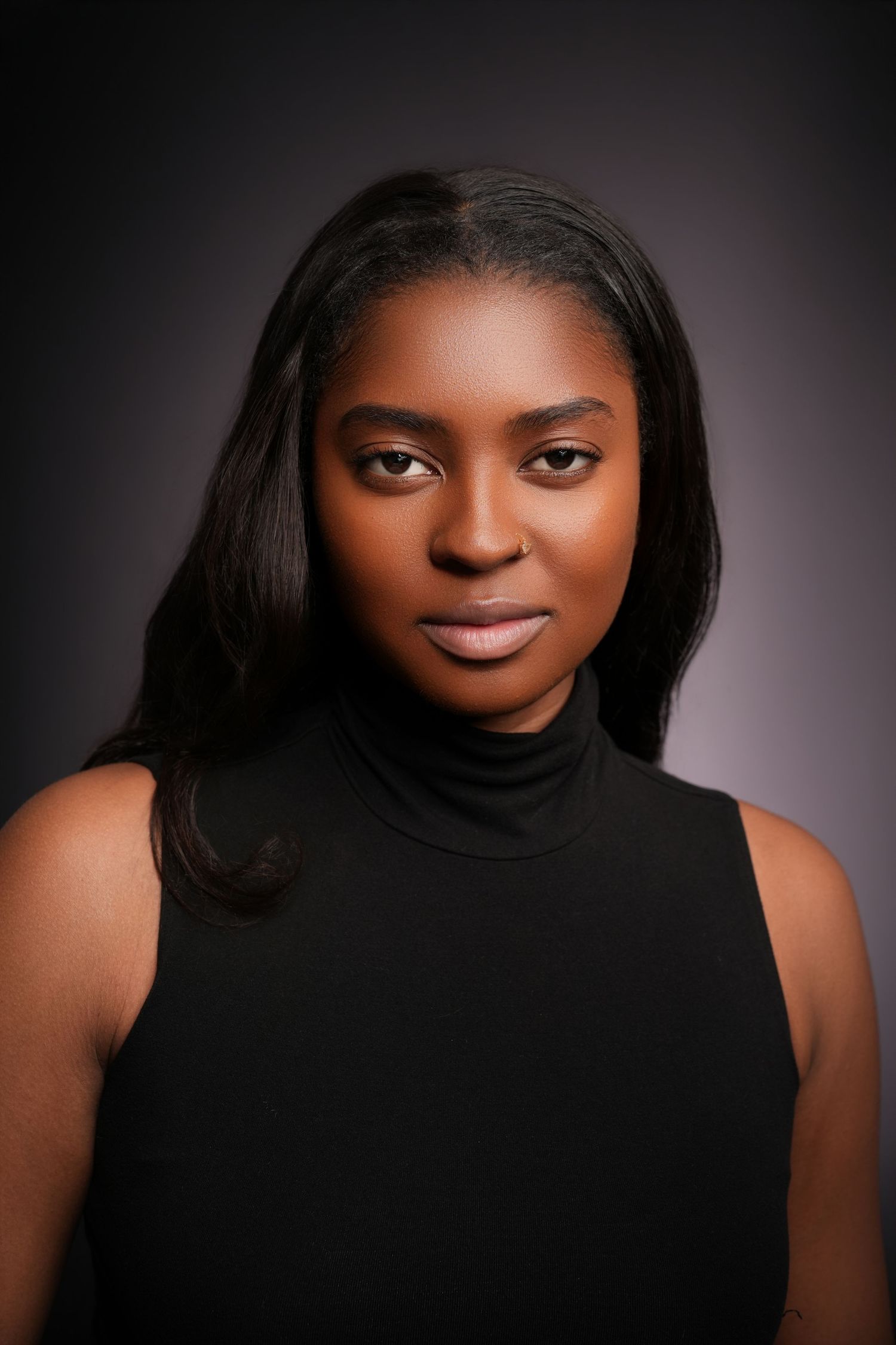 Modern personal branding portrait of a woman with long dark hair wearing a black sleeveless turtleneck in a Charlotte, North Carolina photog