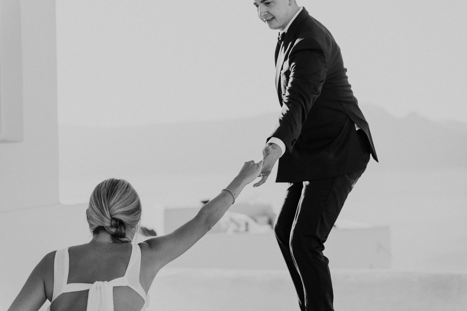A black and white photo sequence showing playful poses on a light background.