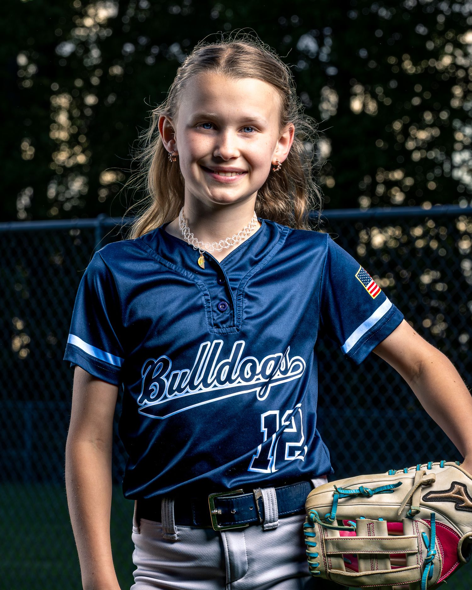 Burke Bulldogs softball portrait by Sporty-Clips Media. Rembrandt strobe lighting, golden hour, elite sheeny blue jersey athlete media.