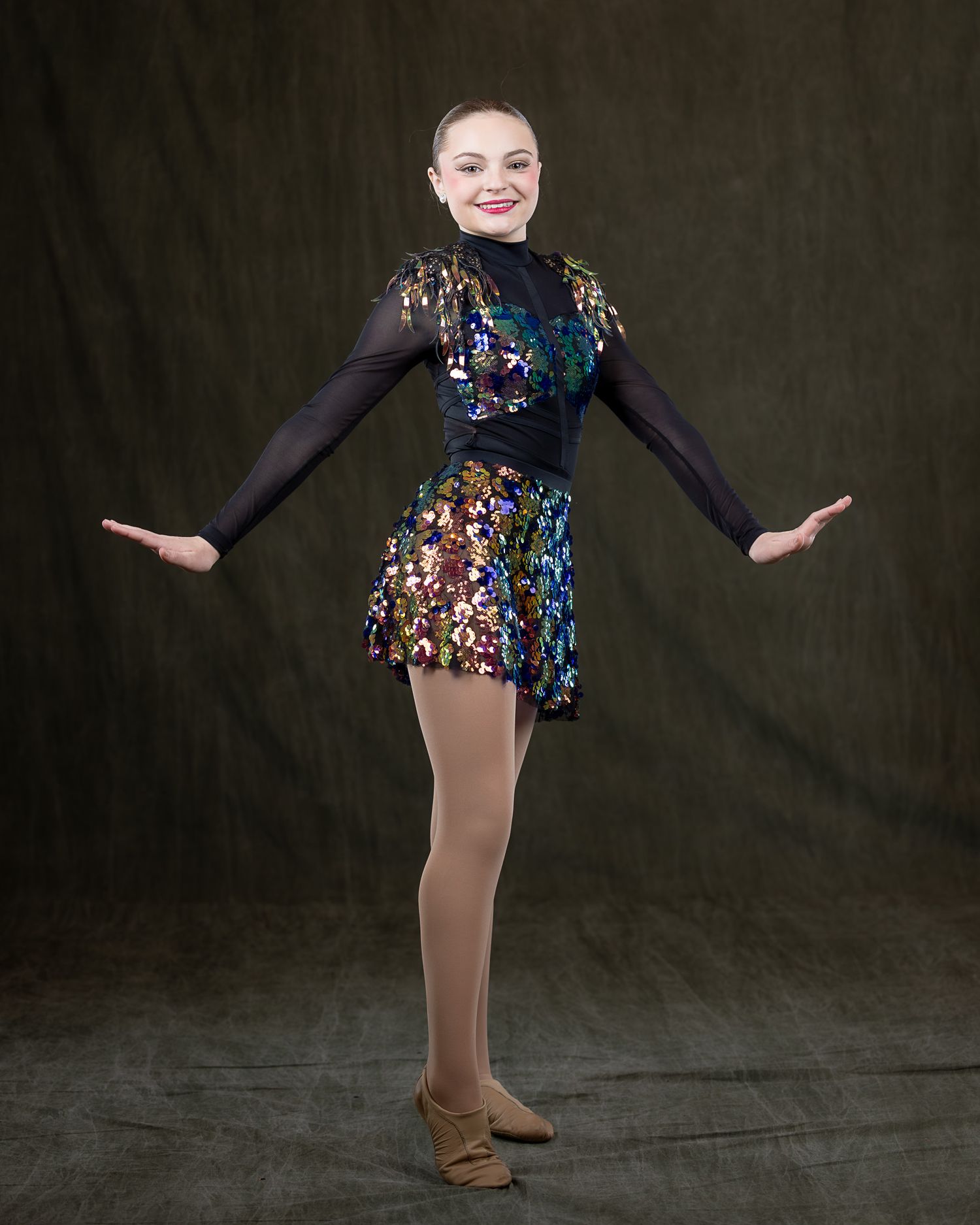 Advanced Musical Theater dancer in sequin costume by Sporty-Clips Media. Professional studio lighting on dark backdrop. High-end dance art.