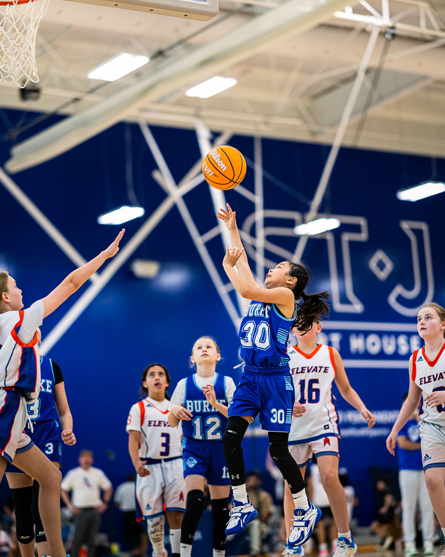 Burke Select 5th grade girls basketball action at The St. James by Sporty-Clips Media. Elite layup shot with blue wall separation.