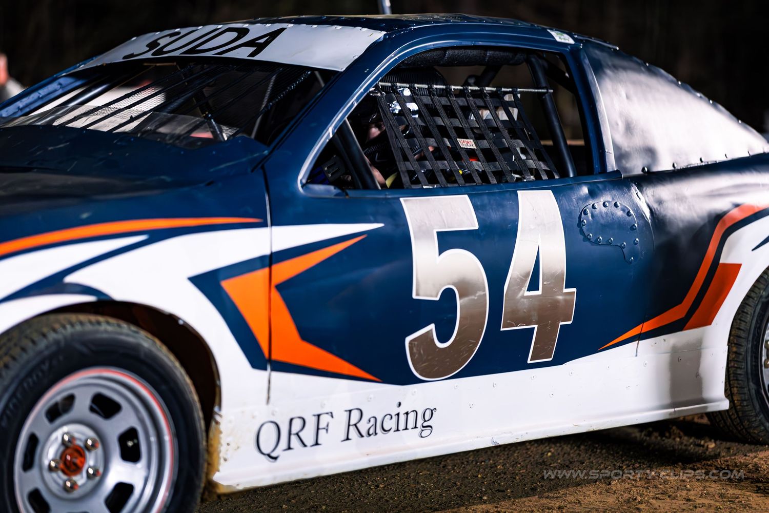 QRF Racing dirt track car at Potomac Speedway. High-speed motorsports action photography R&D by Fairfax-based Sporty-Clips Media.