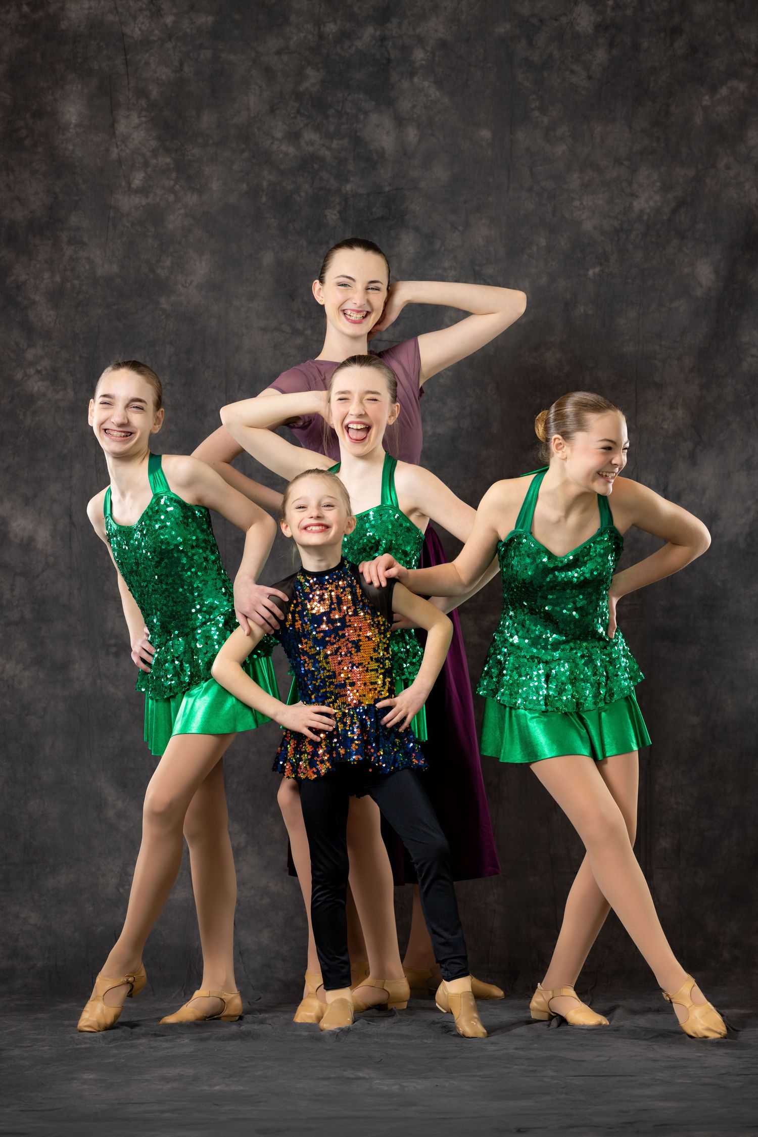 Elite dance group portrait by Sporty-Clips Media. Triple-strobe lighting, sequin costumes, vibrant colors on professional studio backdrop.