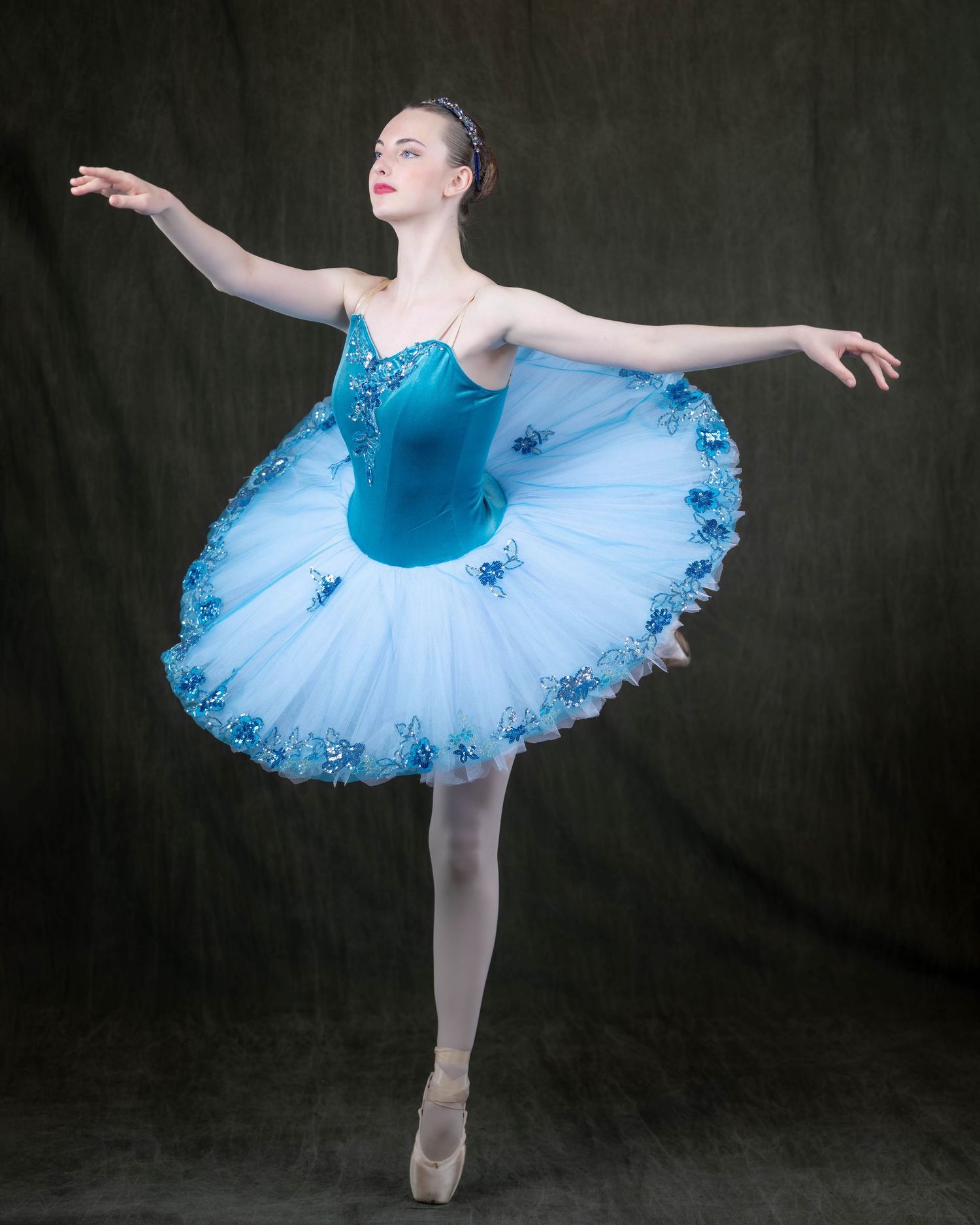 Elite dance portrait by Sporty-Clips Media. Senior dancer in blue tutu with professional four-strobe lighting and high-end studio aesthetic.