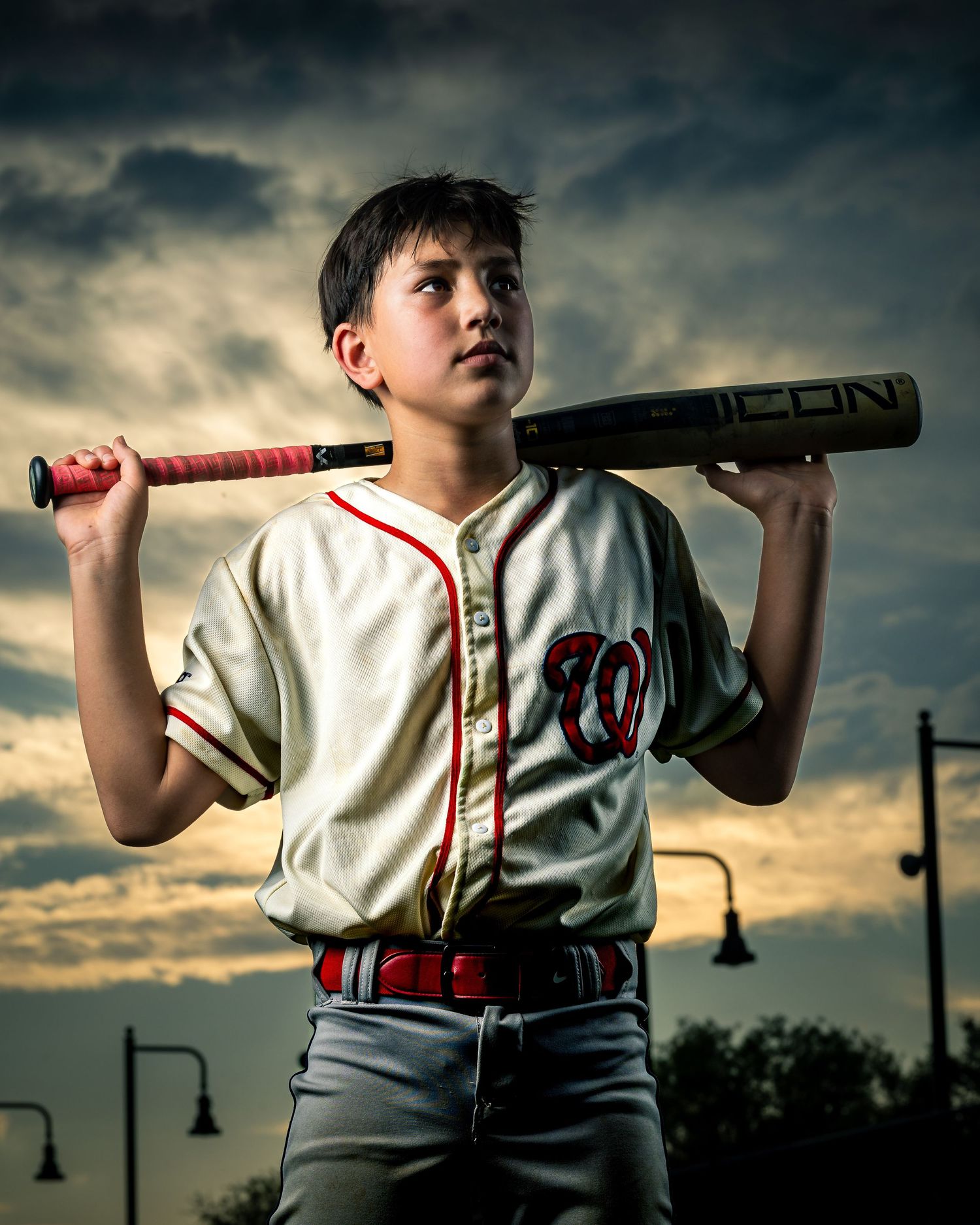 Strobe portrait of Fairfax Little League home run derby winner at dusk, shot at Burke VRE station baseball field by Sporty-Clips Media.