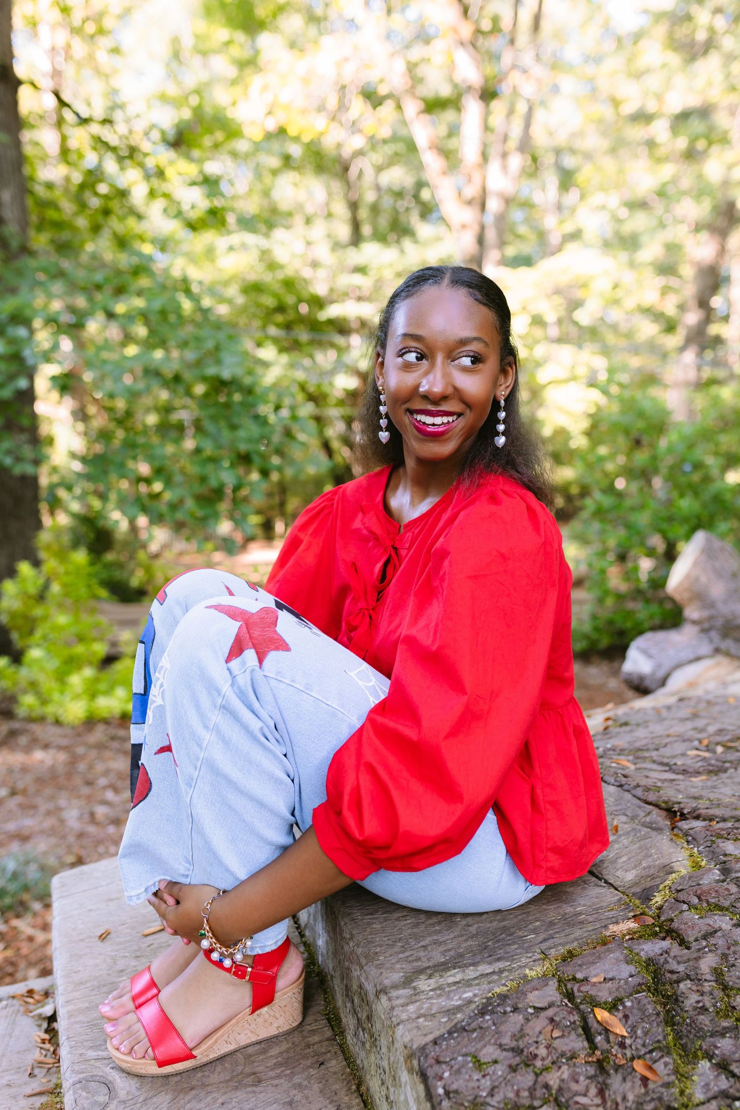 A series of outdoor portraits showing someone in a red top and light colored pants sitting casually on a rock in nature.