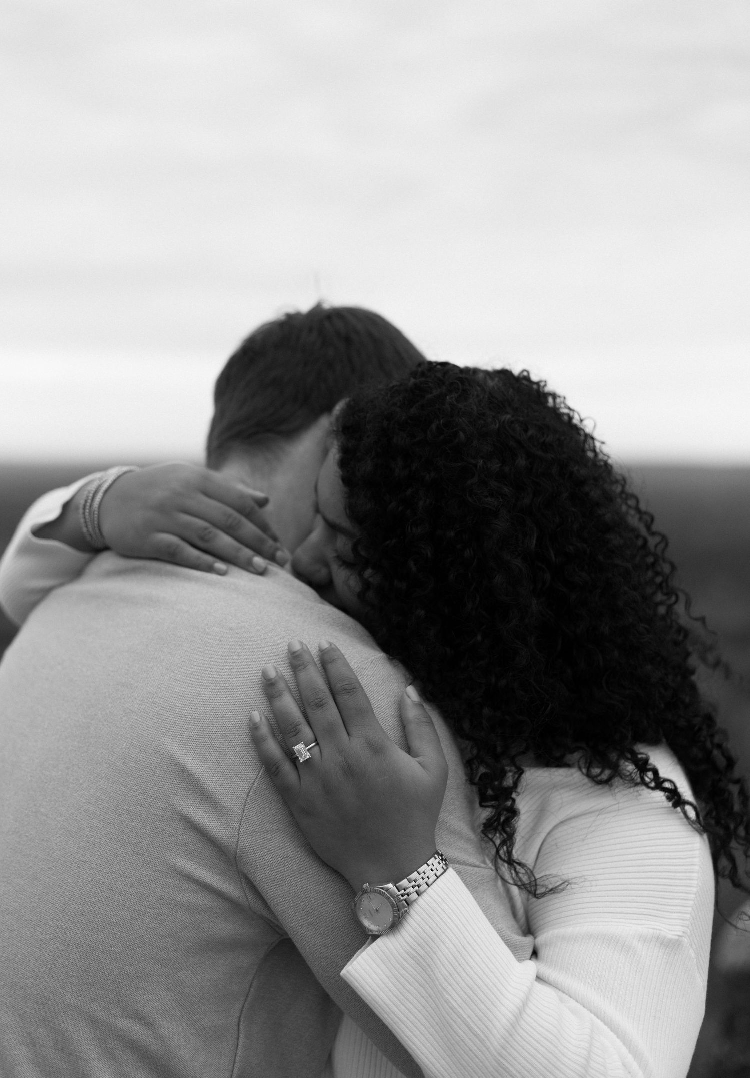 Intimate black and white portrait of couple embracing.