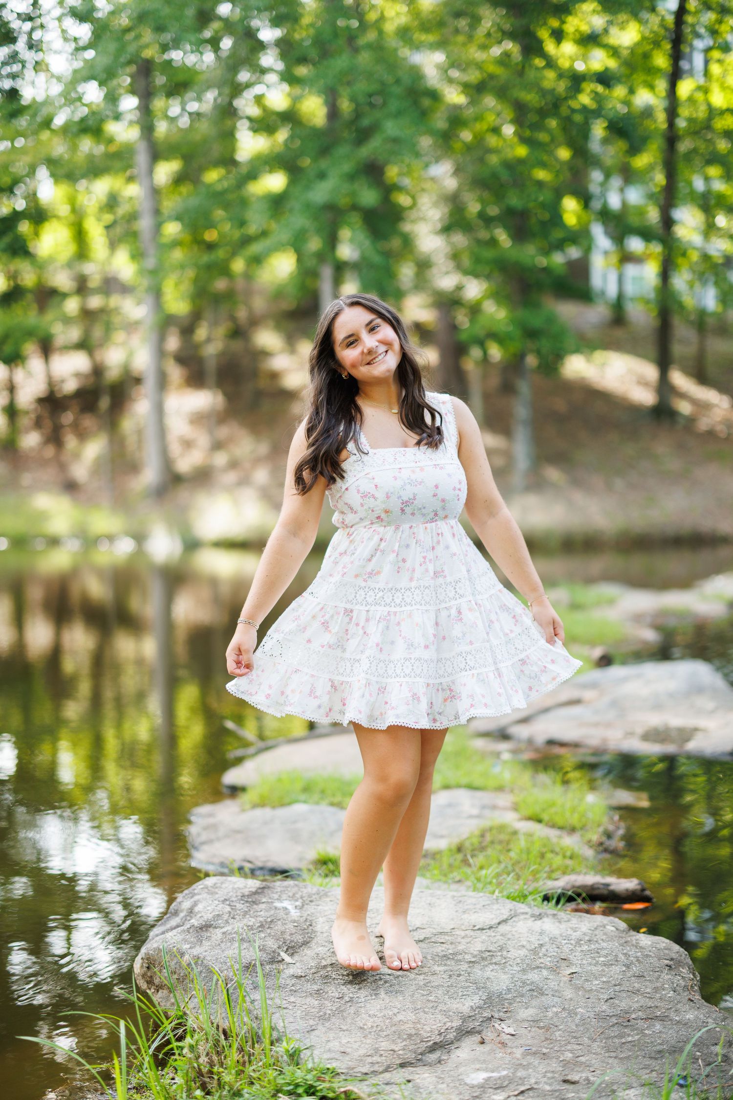 White lace dress photographed in sequence near pond with natural lighting and greenery.