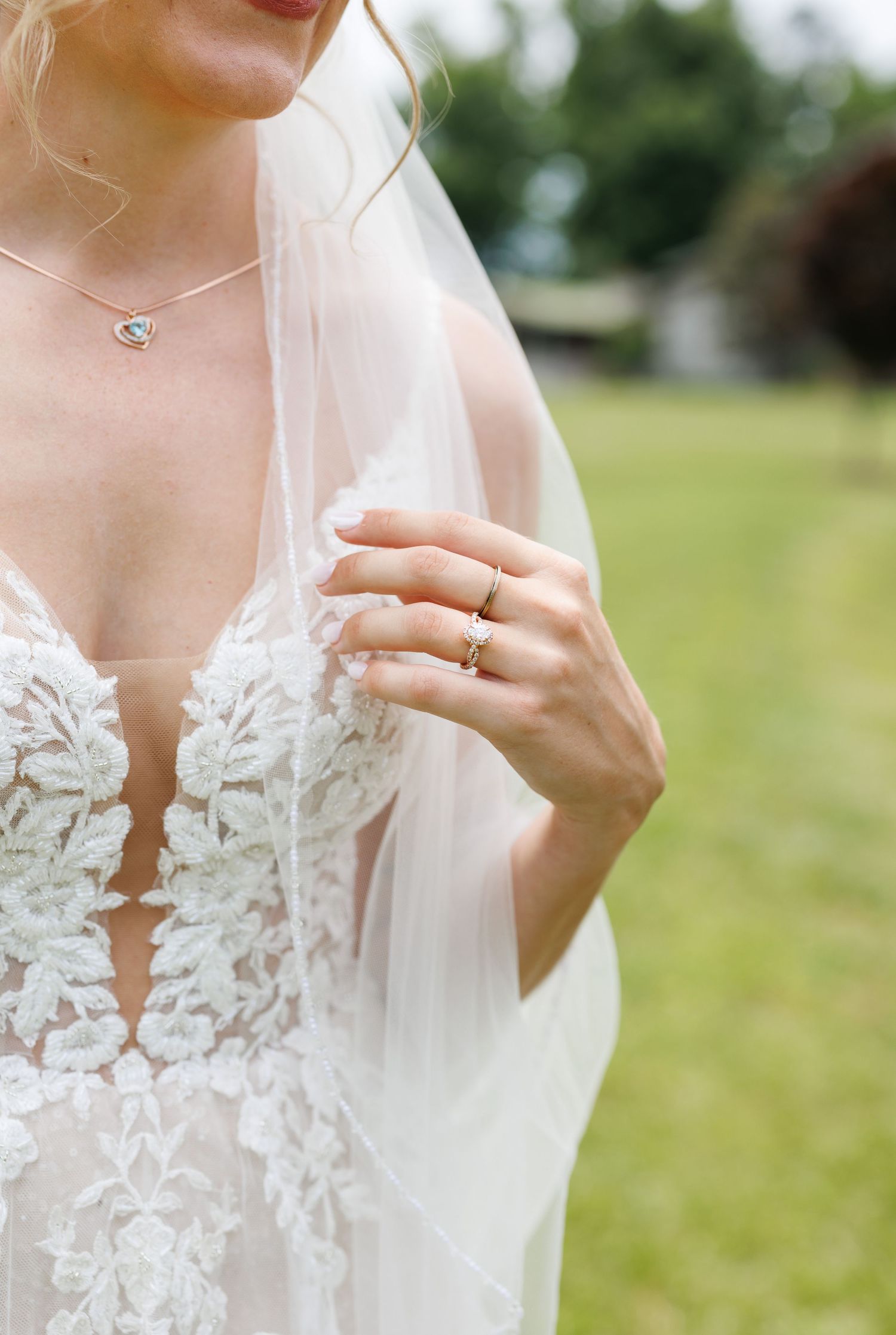Close-up details of delicate lace bodice on a white wedding dress.