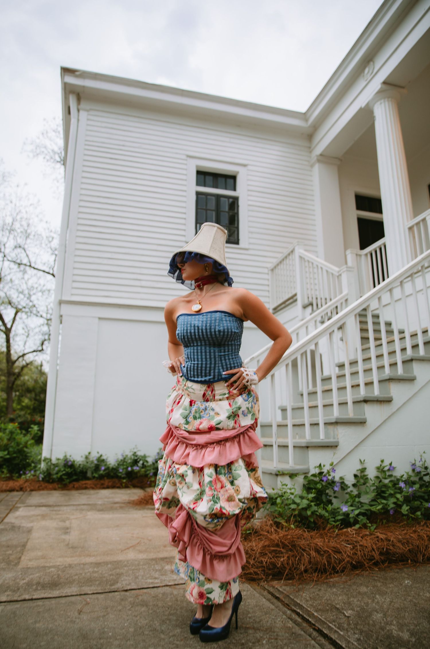 Vintage-inspired outfit photographed outside white colonial style building.