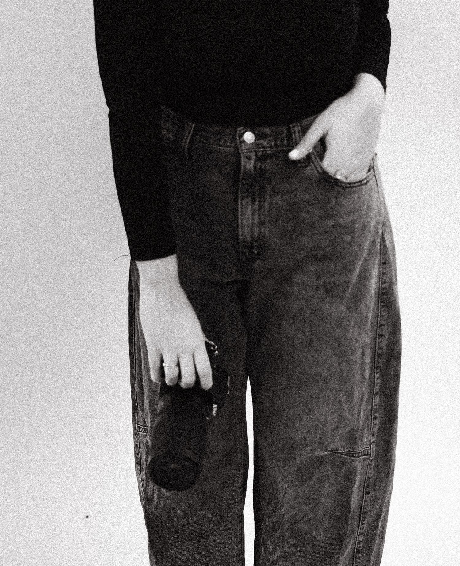 Close-up shots of legs wearing dark denim jeans against white background.