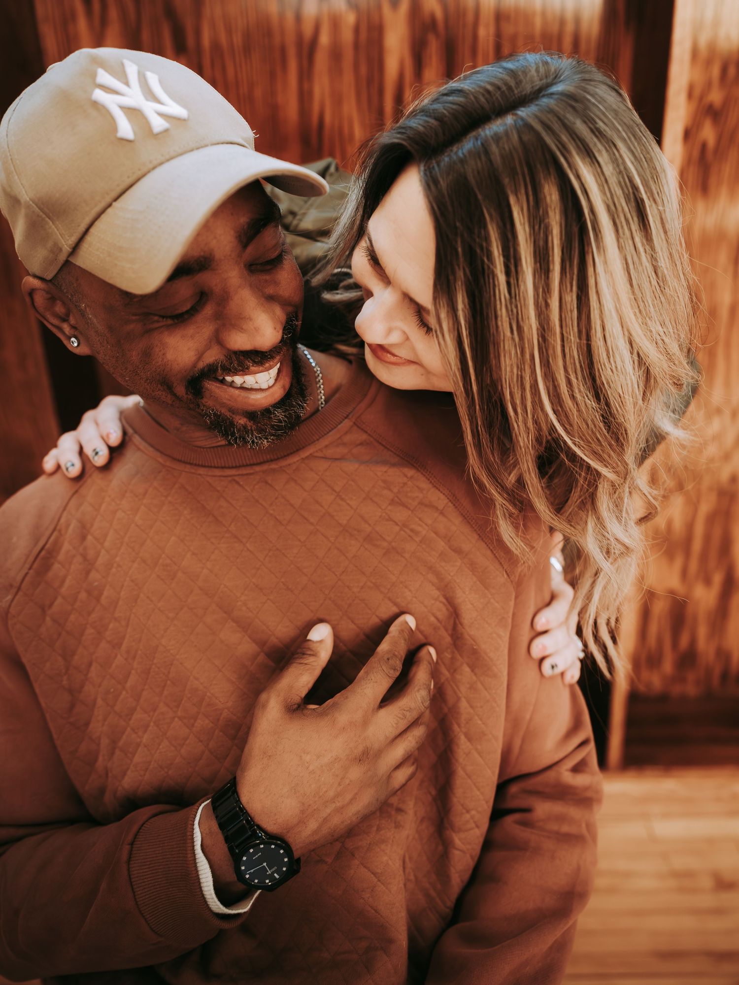 Intimate couple sharing a tender moment together indoors with warm lighting.