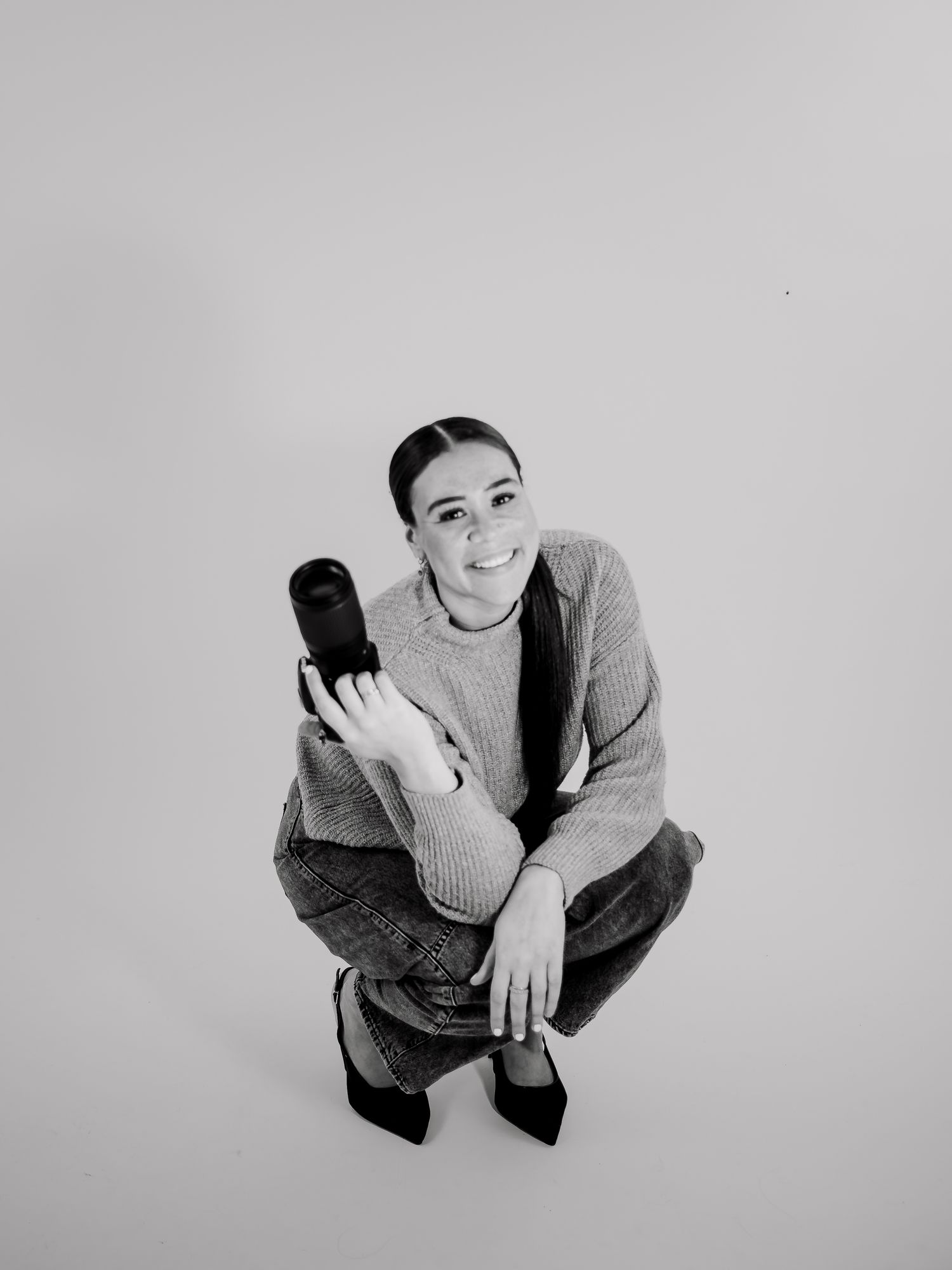 High angle fashion shots showing model in grey sweater posing from above.