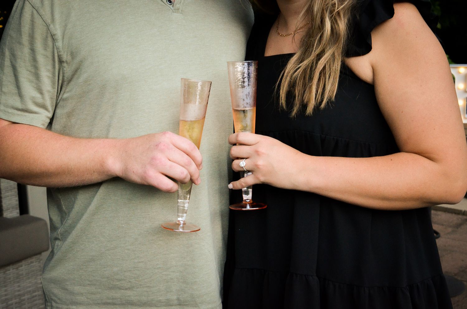Two people holding champagne glasses in a celebratory moment.