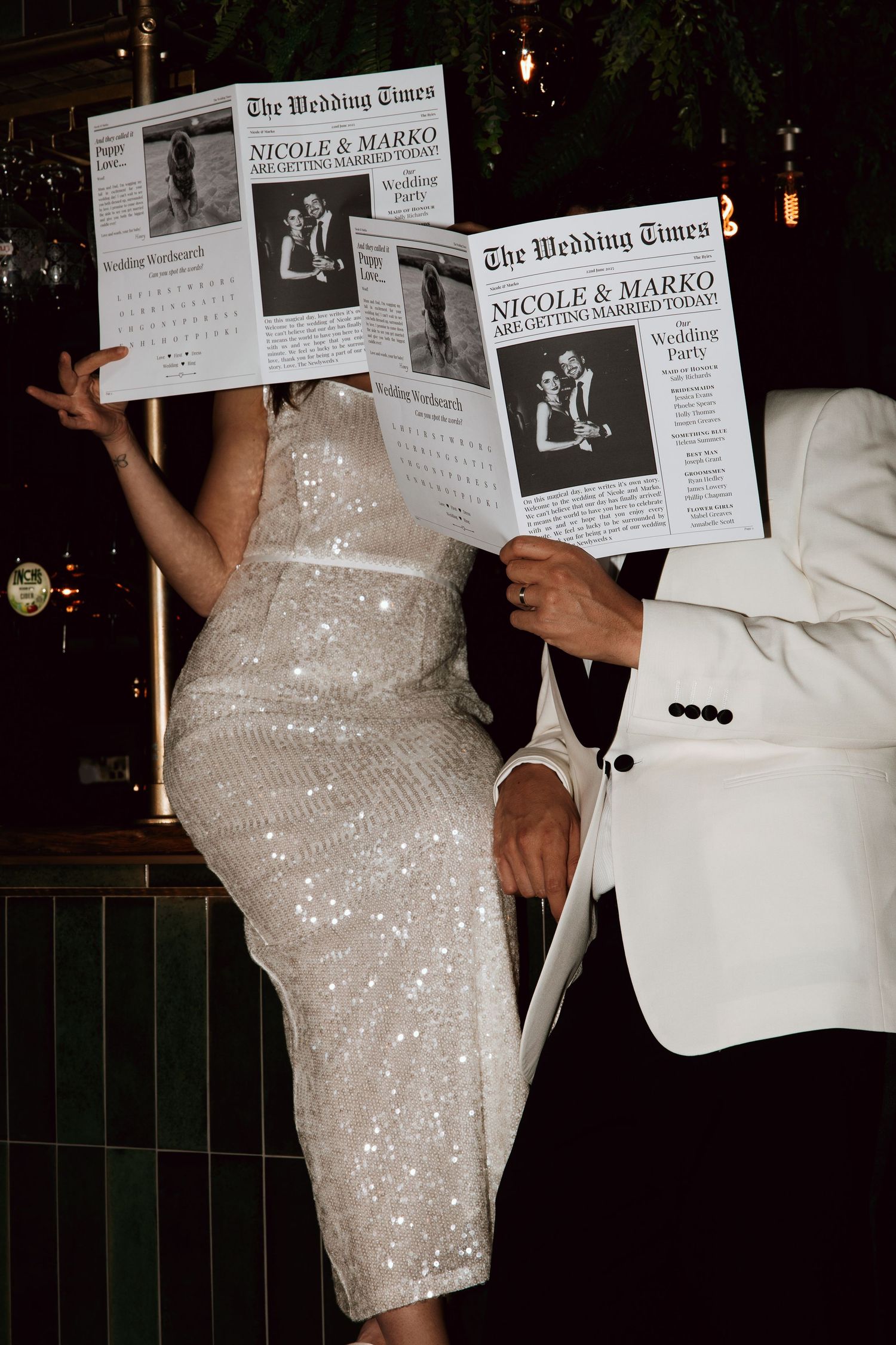 Nicole and Marko hold custom wedding newspaper programs at their glamorous evening reception.
