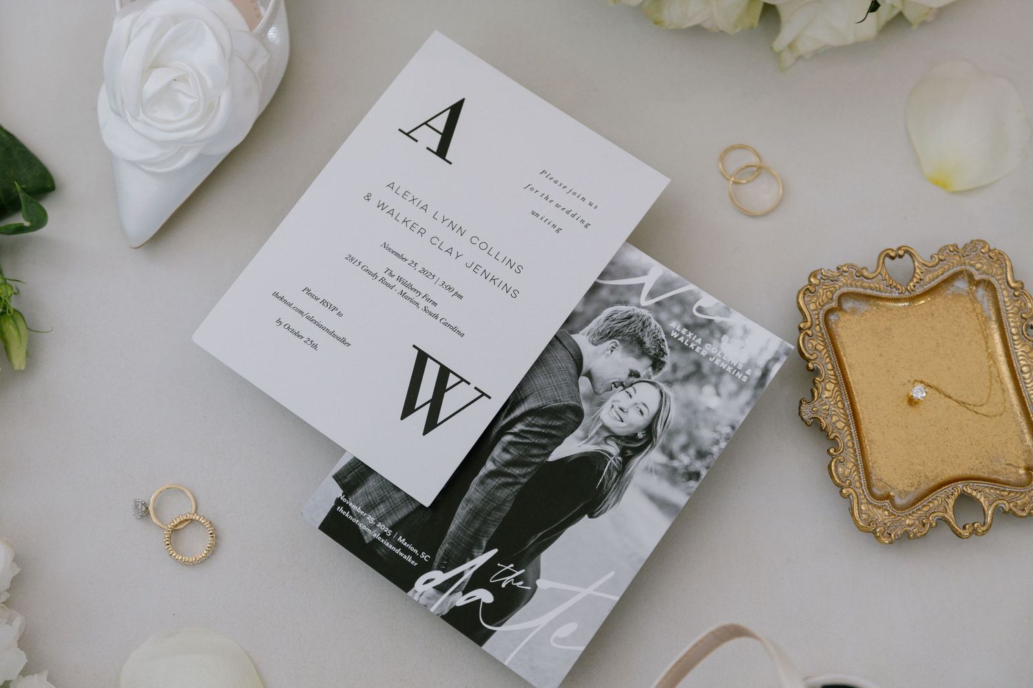 Elegant wedding invitation suite with monogram initials A and W, featuring a black and white couple photo, rings, and white roses.