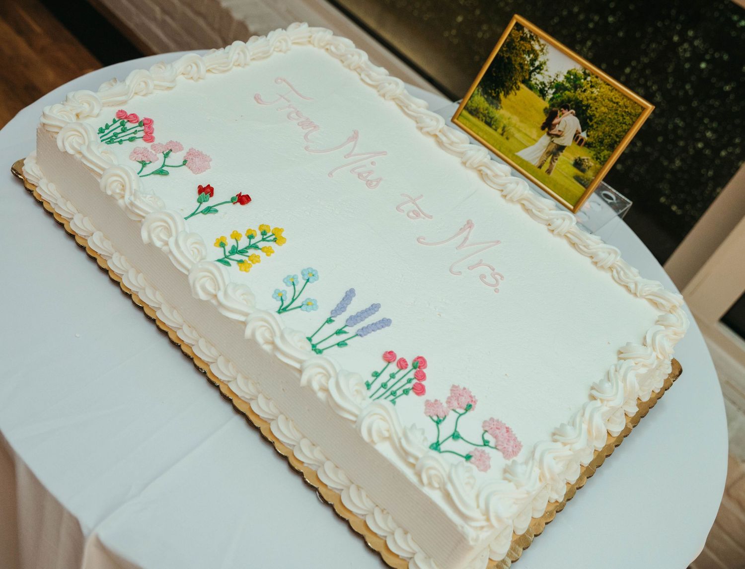 Wedding sheet cake decorated with colorful floral designs and 