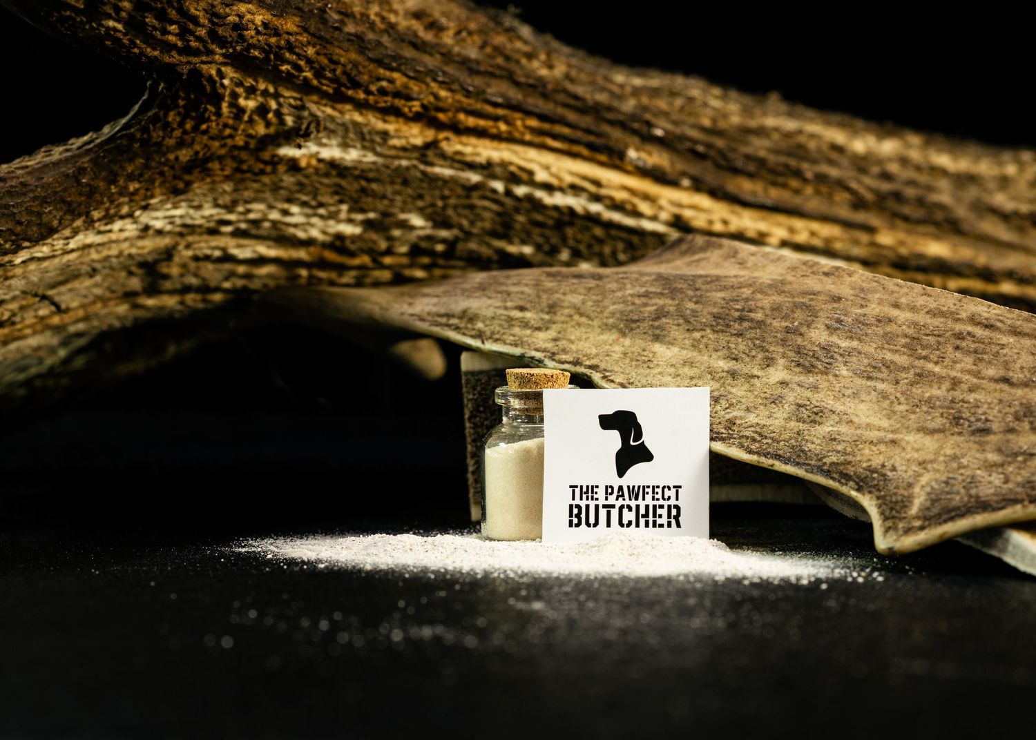 Food and product photography and videography A butcher shop logo displayed next to a small glass jar against rustic wood background.