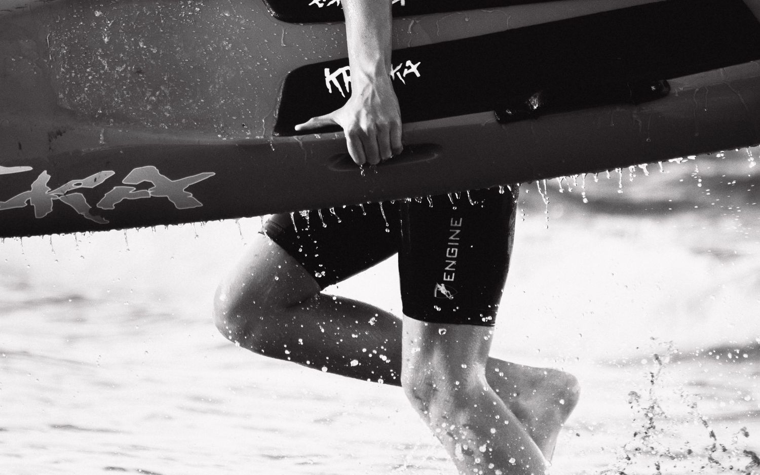 Sydney Sutherland Shire photographer and videographer Close-up action shots of surfboard cutting through ocean spray in black and white.