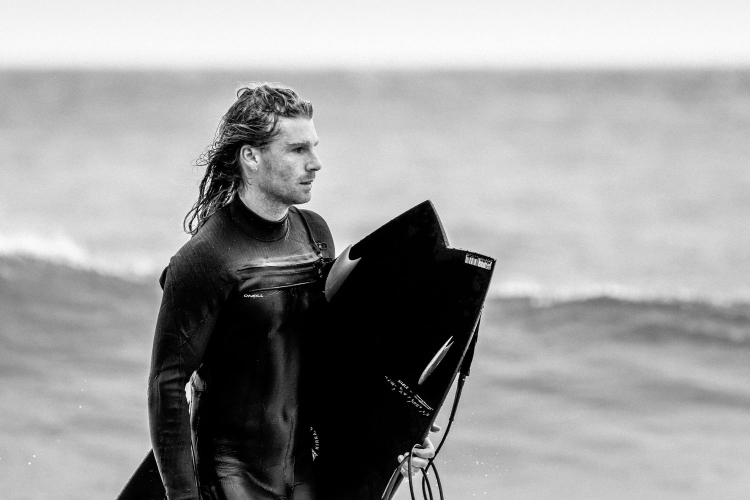 Sydney Sutherland Shire photographer and videographer Black and white profile shots of surfers in wetsuits with their boards.