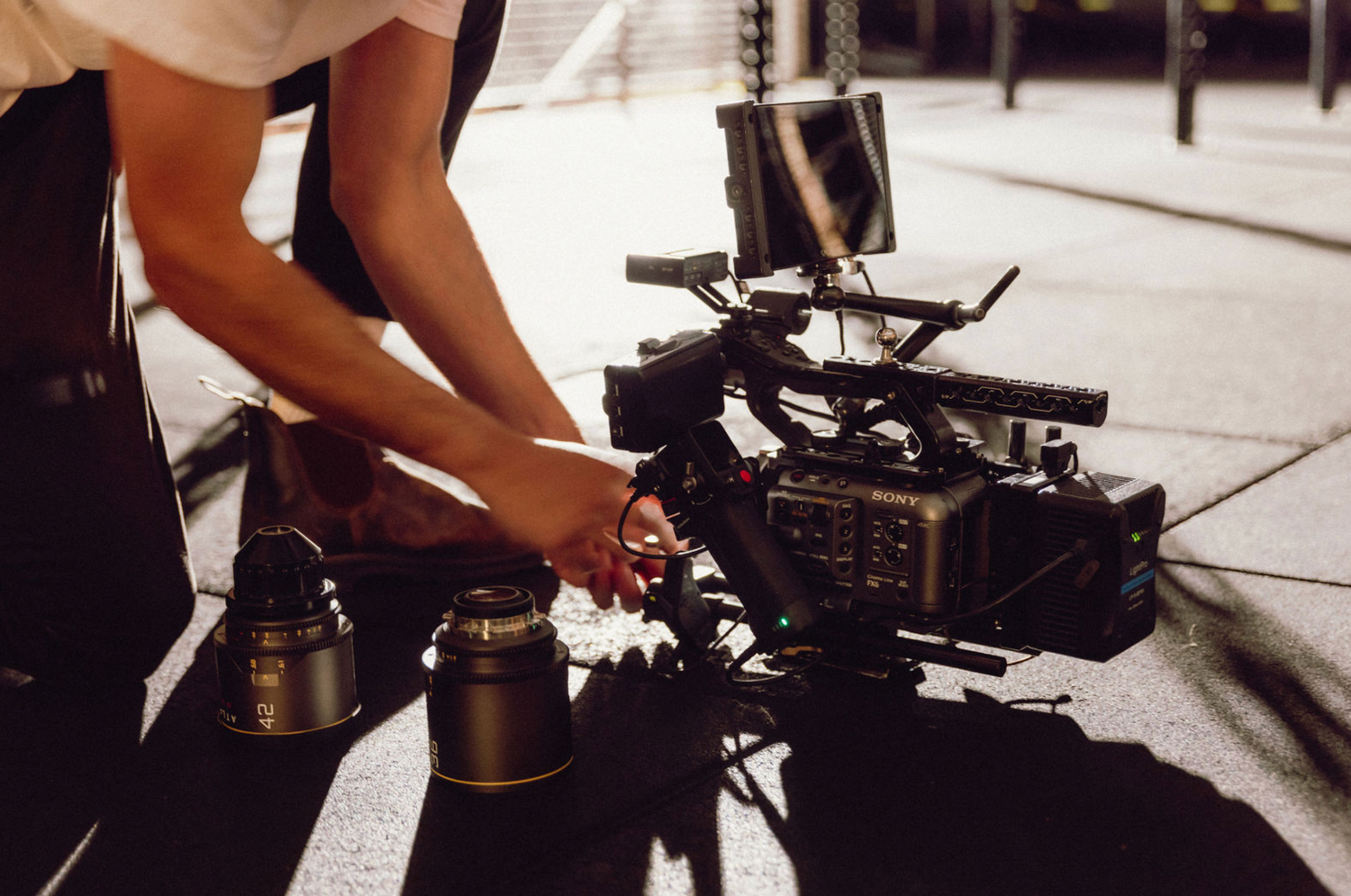 Close-up view of camera equipment being adjusted on a low-angle setup. Professional videographer in sydney