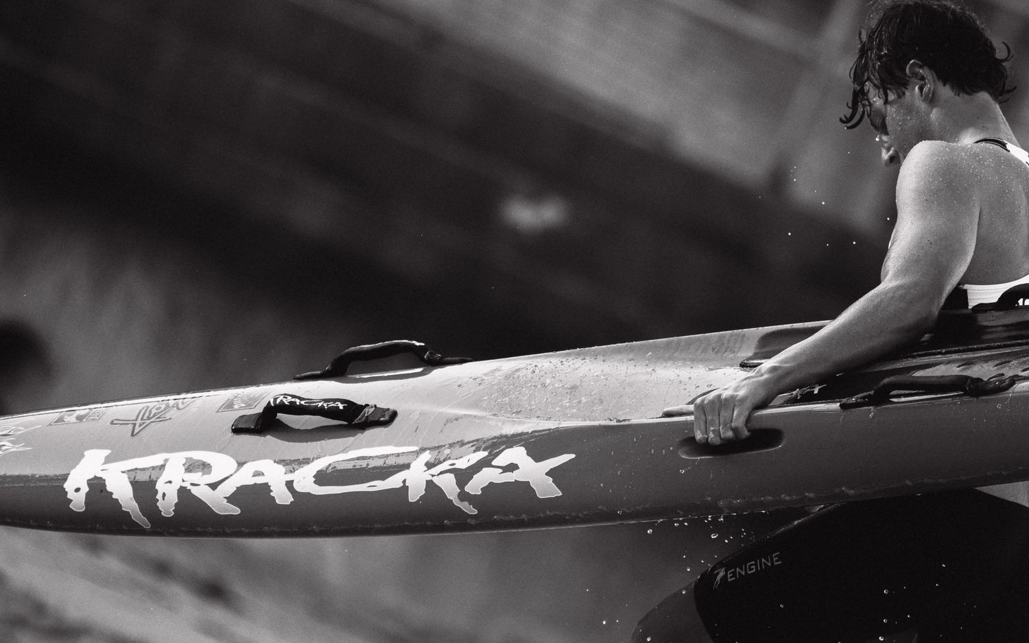 Sutherland Shire photographer and videographer Close-up black and white detail of surfboard on water surface.