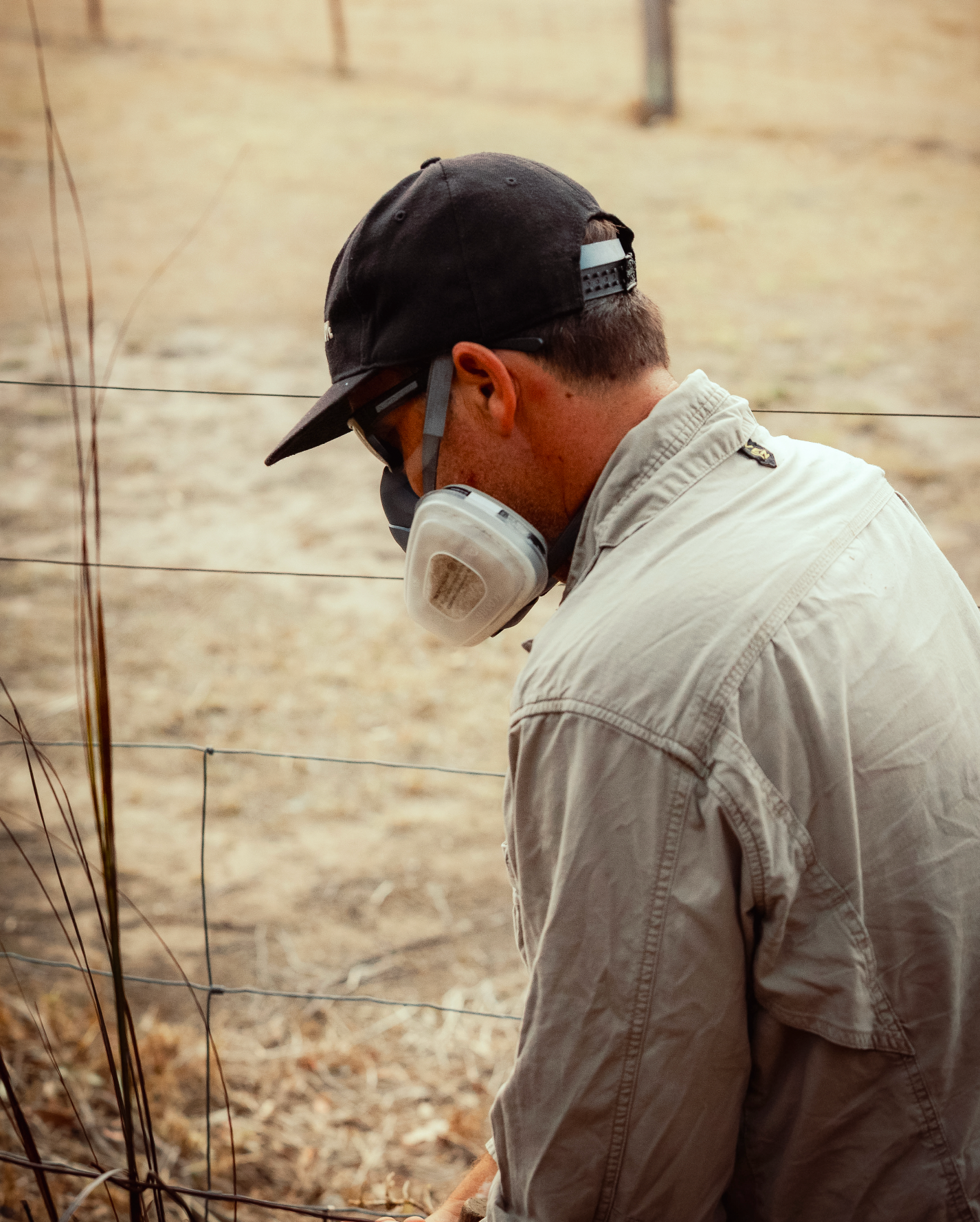 Branding and business photography and video Person wearing safety equipment and protective mask while working outdoors in dry conditions.
