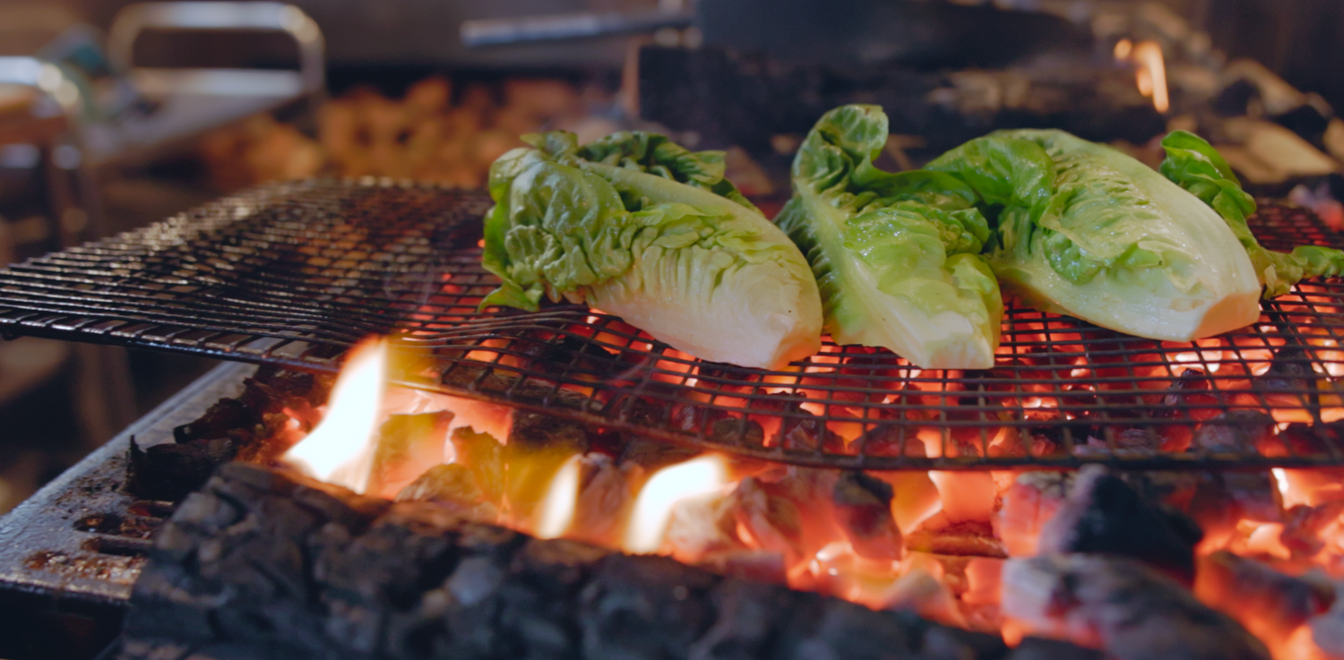 Documentary and film still - Fresh vegetables grilling on a hot barbecue grill with flames. Cooking, food, lifestyle photography and video