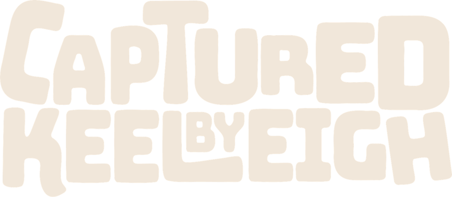 Blurred text in muted beige and brown tones creates an abstract background pattern.
