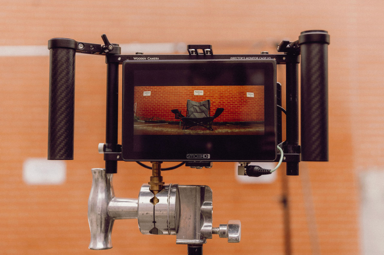 Professional camera rig mounted on stabilizing equipment against orange background. Professional videographer in sydney