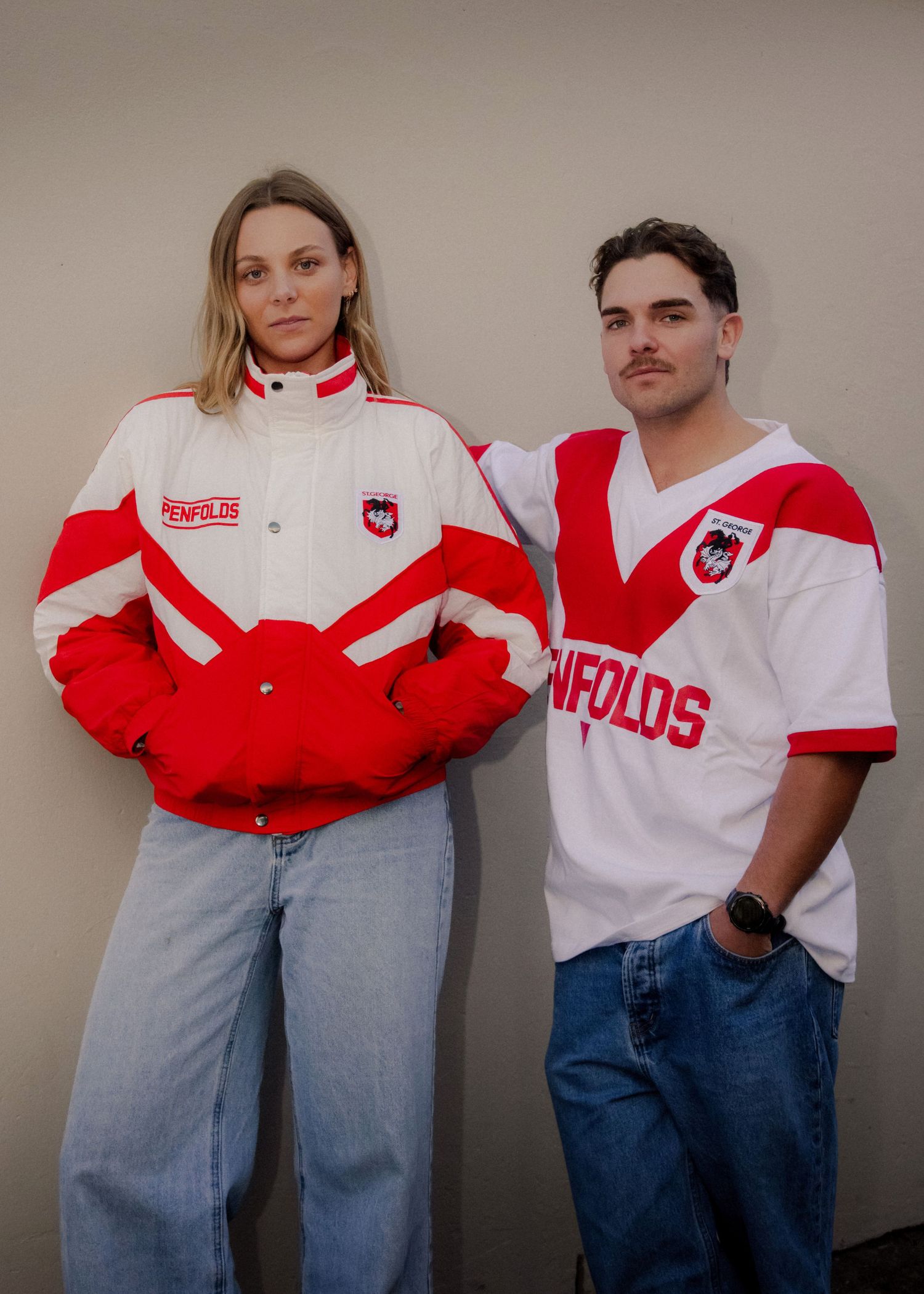 Two models wearing vintage Penfolds St George Dragons NRL rugby league jacket and jersey.