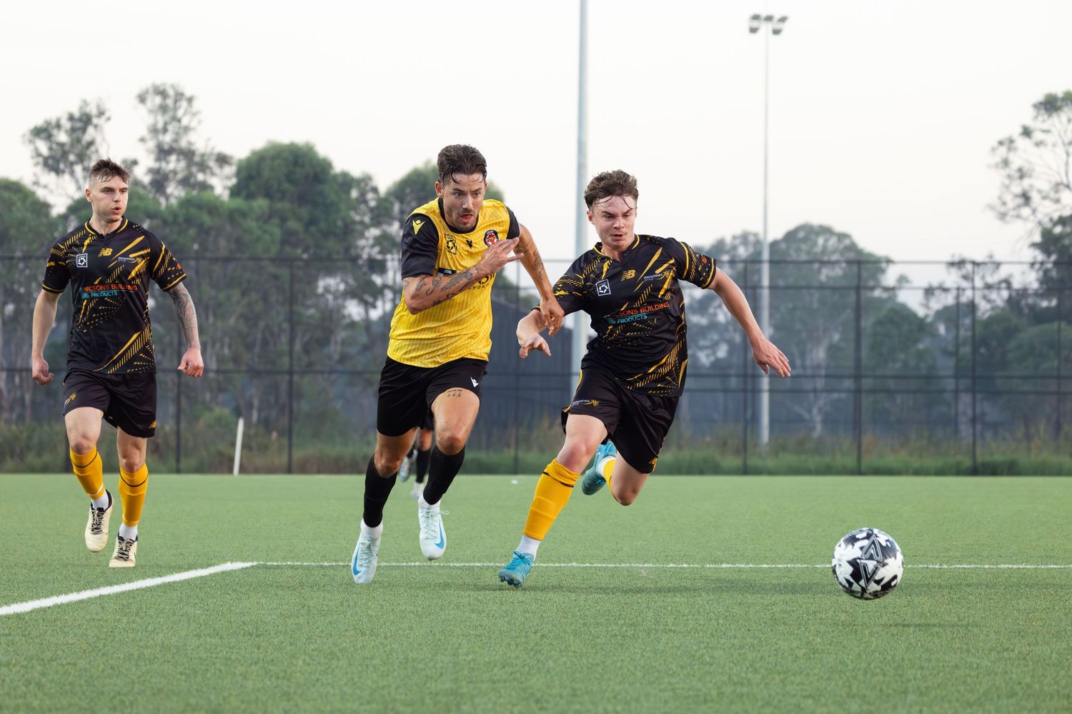 Wollongong photographer Soccer players chase after the ball during competitive match on artificial turf.