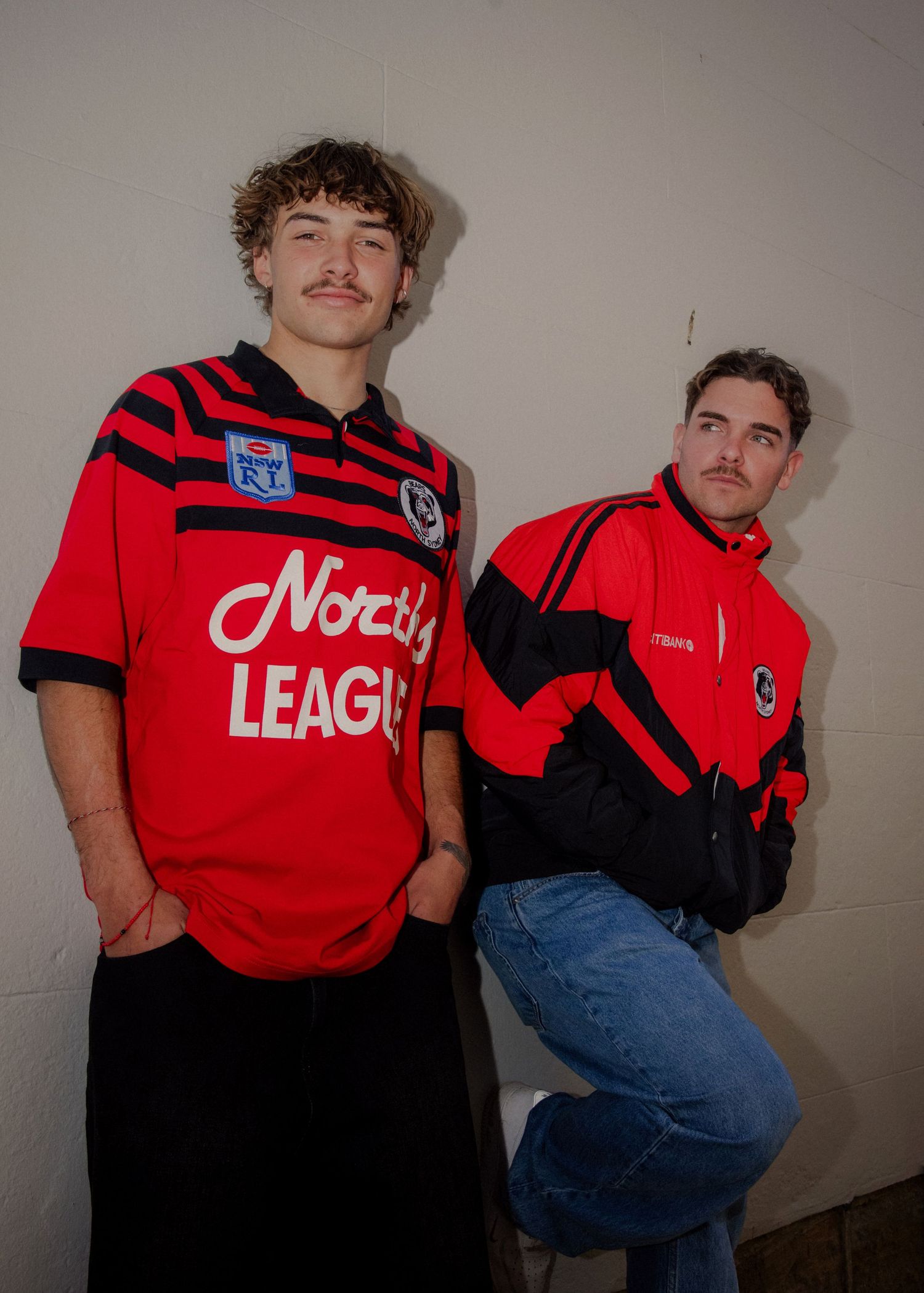 Two male models wearing retro red and black NRL North Sydney Bears rugby league jerseys and jackets. Sutherland Shire videographer