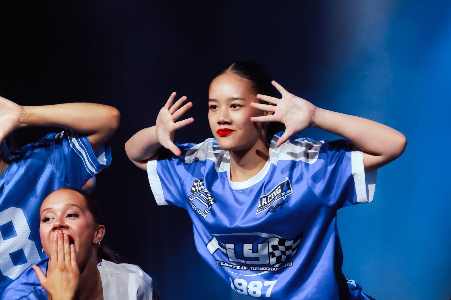 Dance performance with children in blue outfits against a dark background. Sutherland Shire dancers, photography of dance
