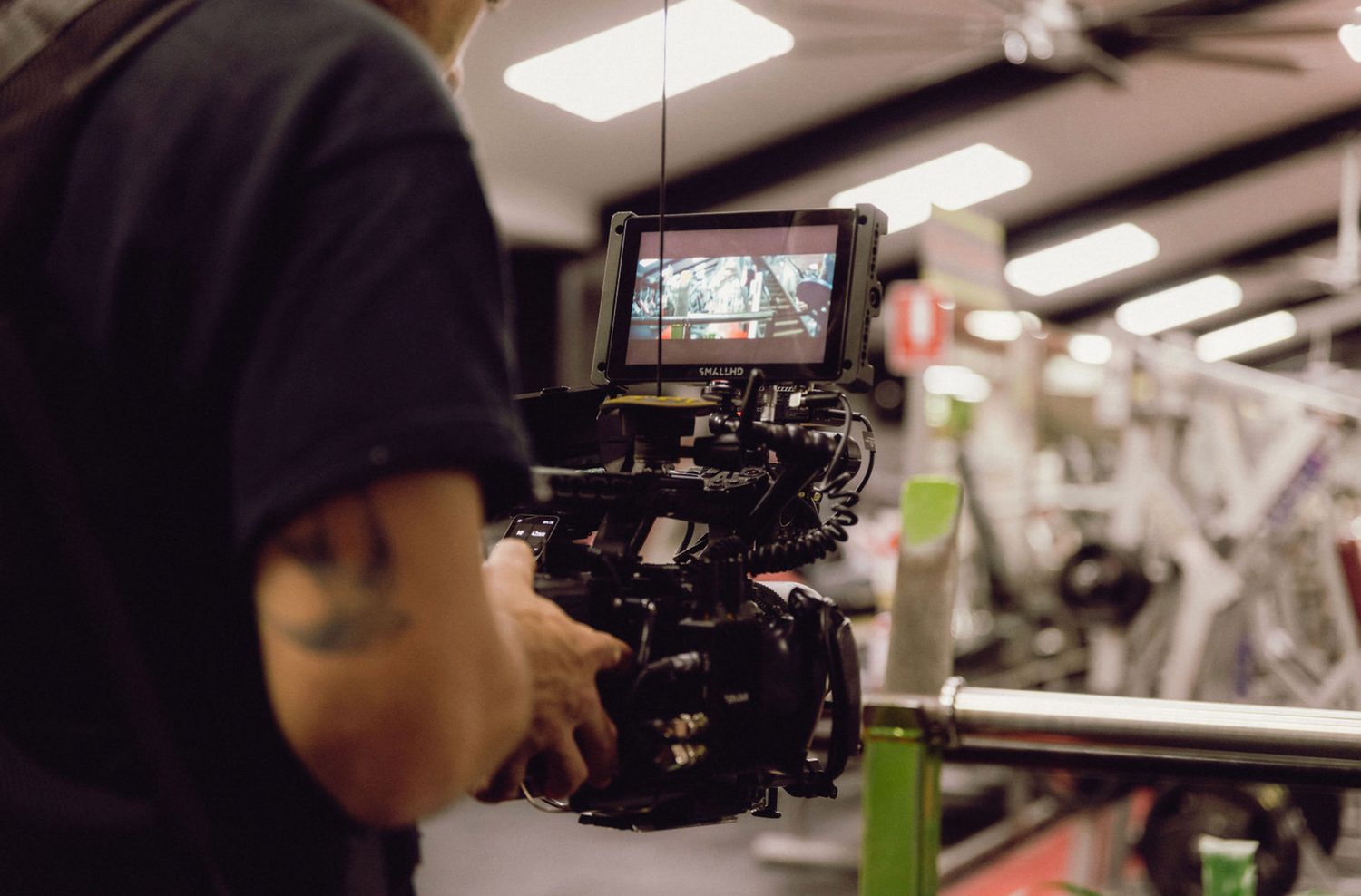 Videographer working with professional camera equipment in a commercial space. Professional videographer in sydney