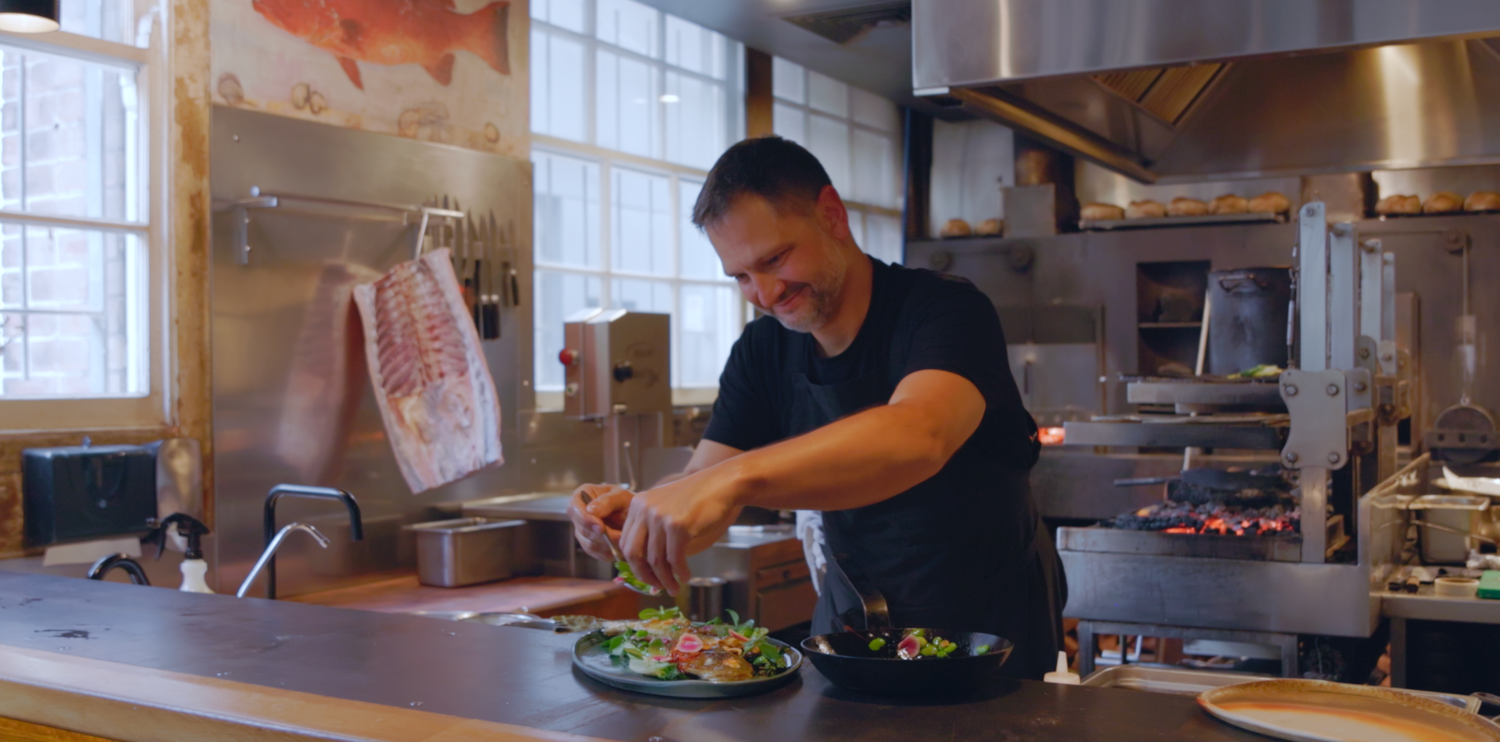 Documentary film maker in Sydney shows Professional chefs working in a modern restaurant kitchen preparing meals Sydney Restaurant Firedoor