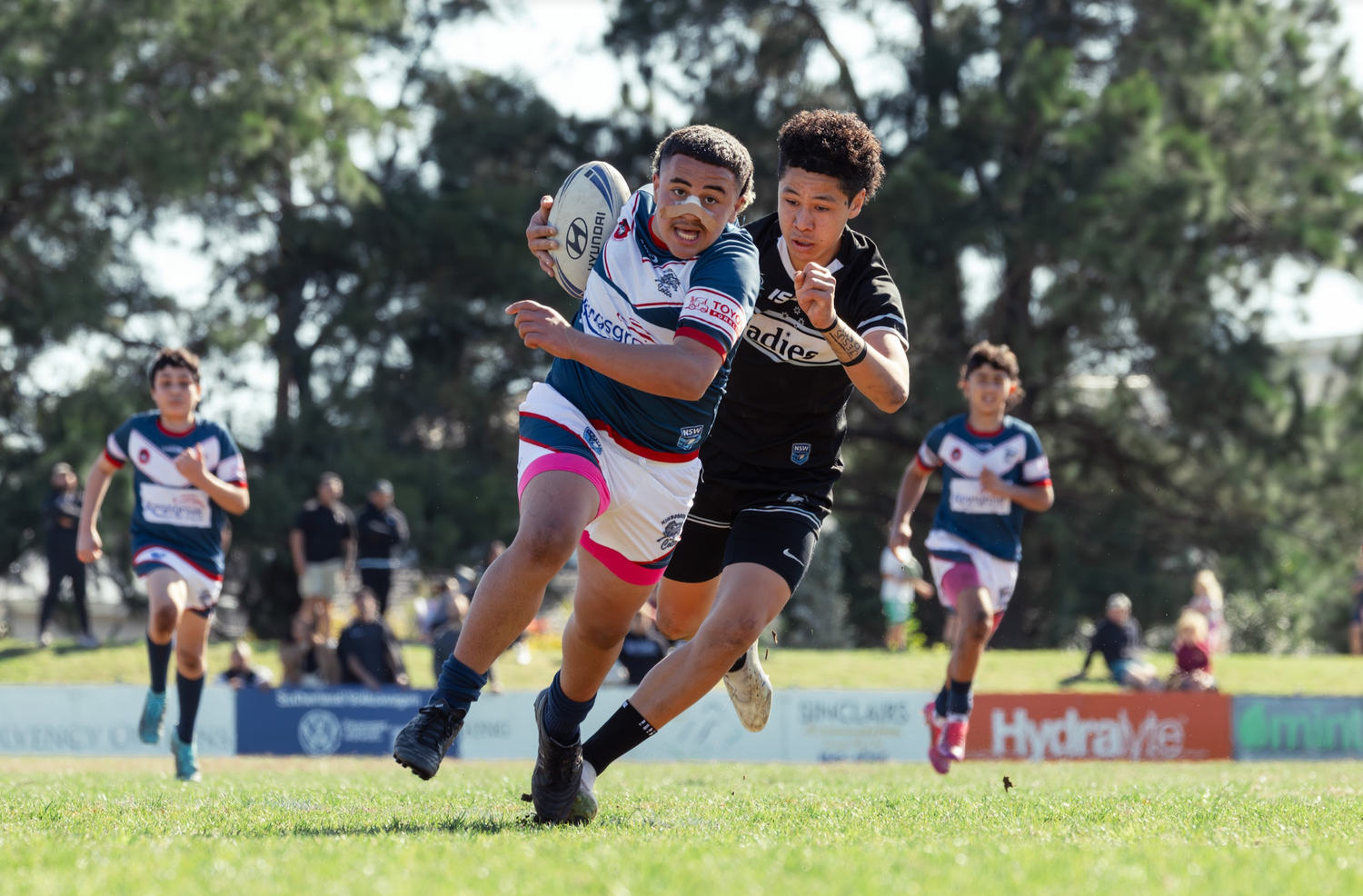 Wollongong sports photographer captures Rugby players competing for ball possession during intense match action.