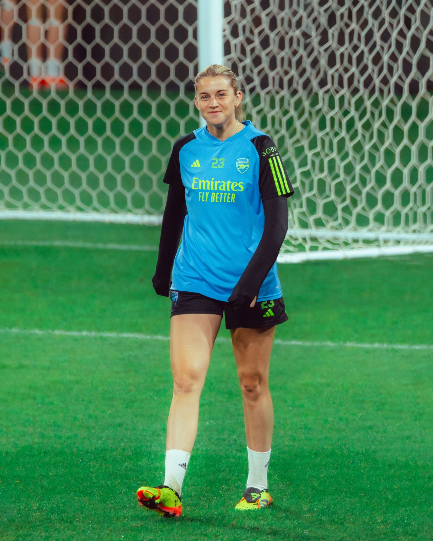 Wollongong sports photographer capturesClose-up of soccer goalkeeper's feet and legs against net during training.