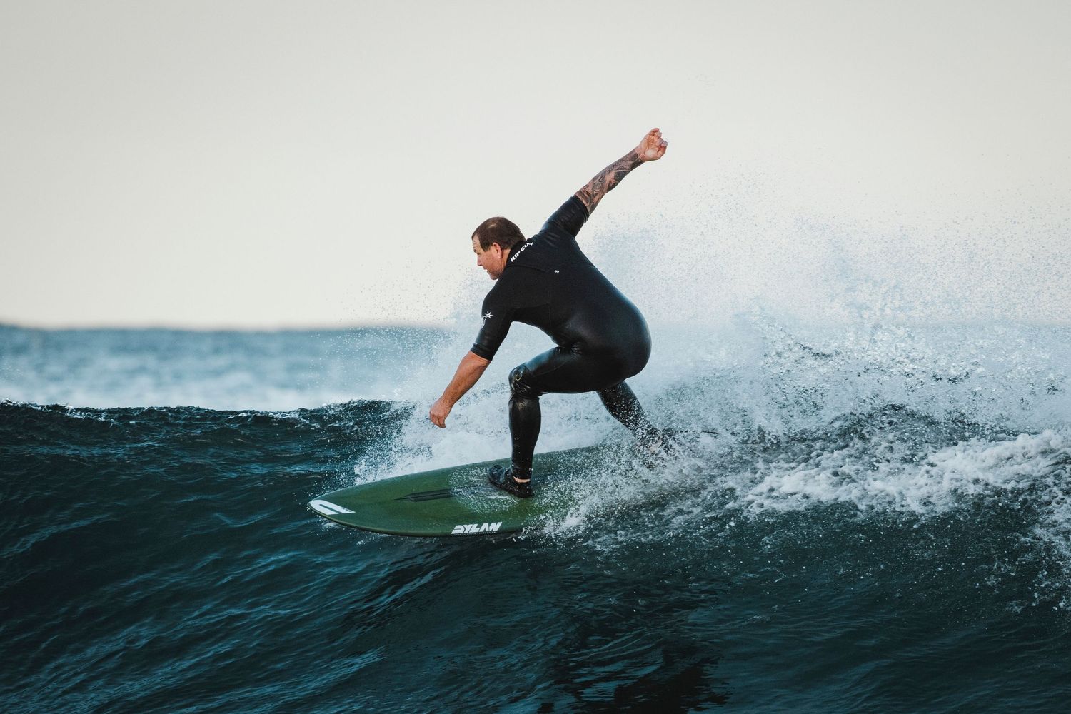 Wollongong photographer and videographer Multiple action shots of surfer riding waves and performing turns in sequence.
