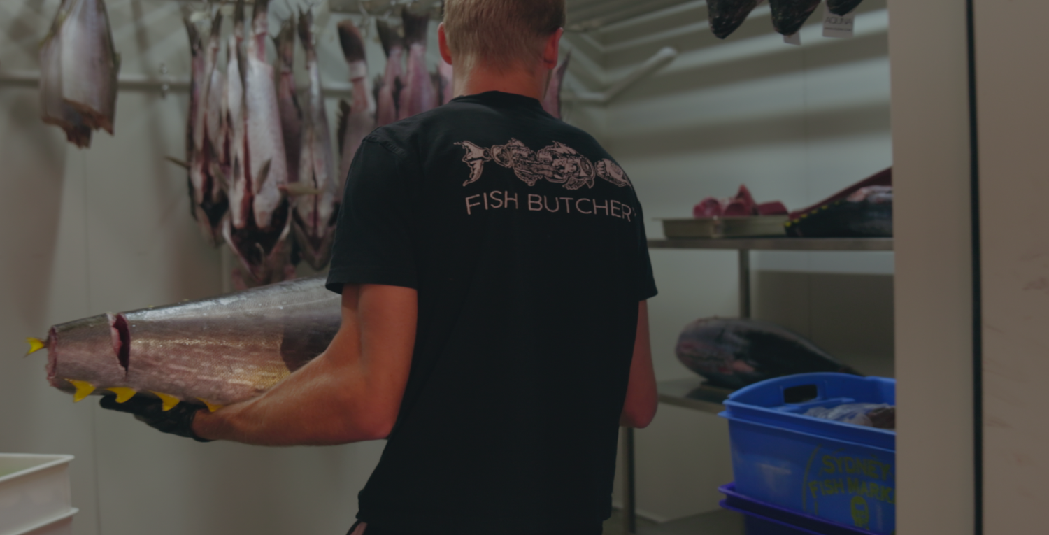 Wollongong based videographer captures Fresh ingredients being prepped on a stainless steel kitchen counter with utensils.