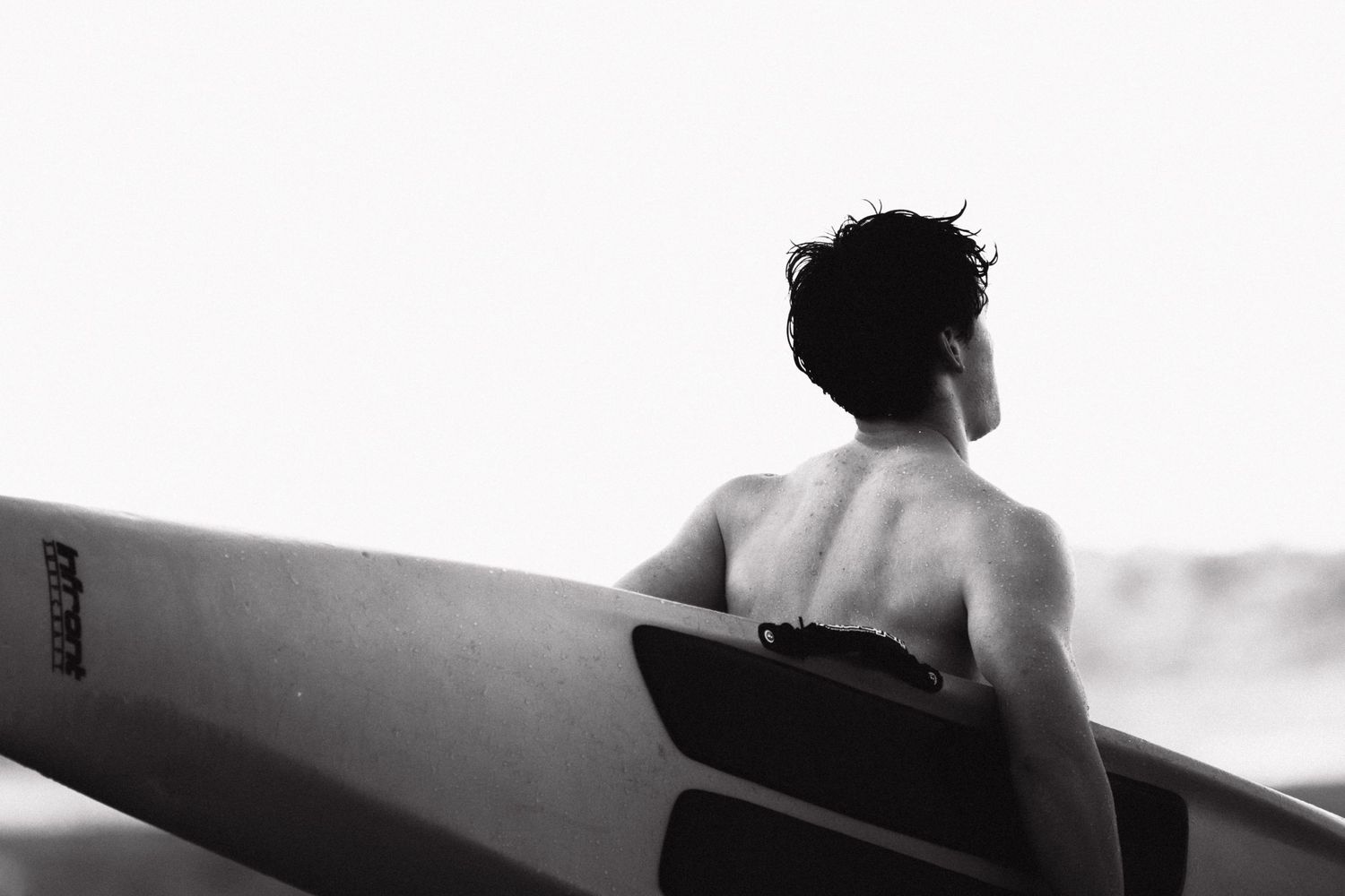 Sydney Sutherland Shire photographer and videographer Minimalist black and white shot of surfers walking with their boards.