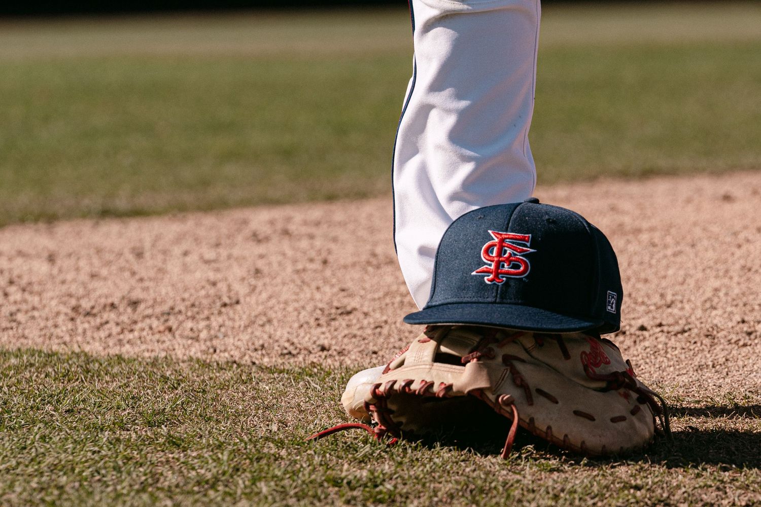 A sequence of baseball players' feet and cleats shown in motion on the infield dirt during a game.