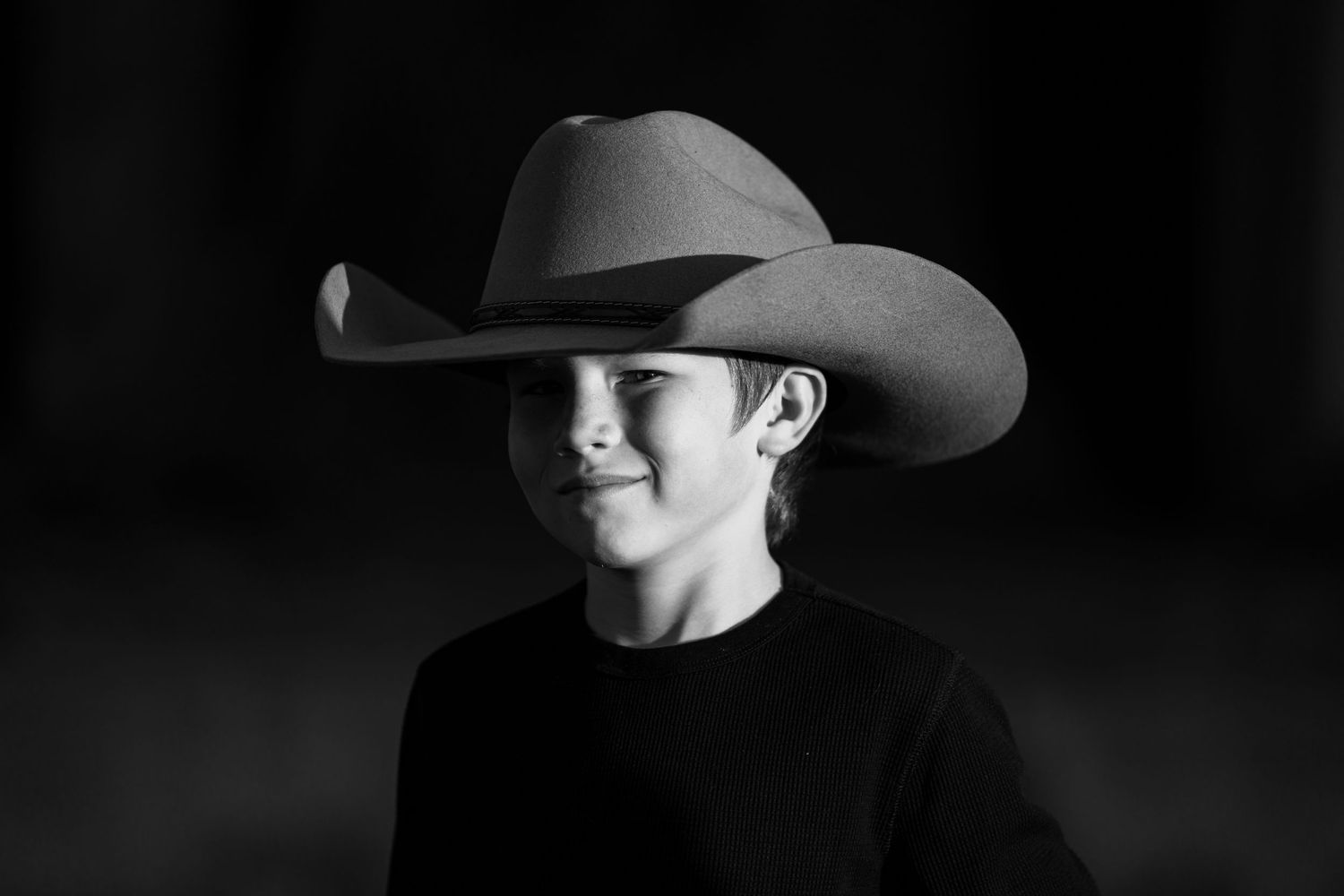 Dramatic black and white portrait series featuring a cowboy hat silhouette.