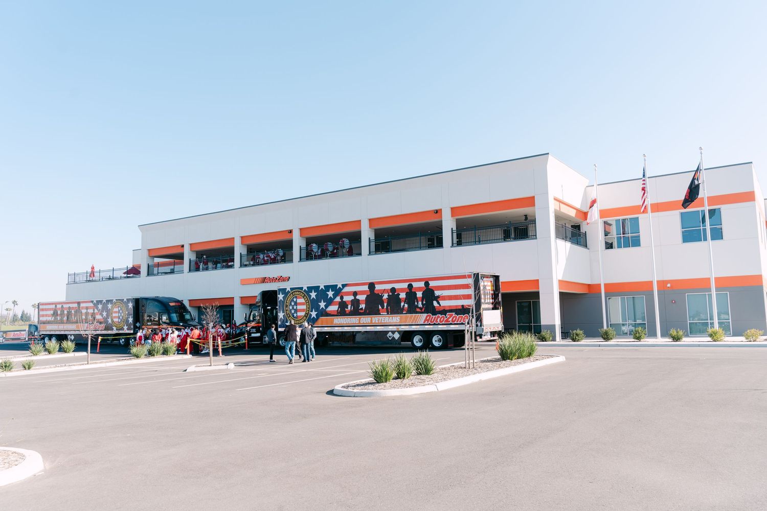 Panoramic view of a modern industrial warehouse complex with loading docks and white exterior walls.