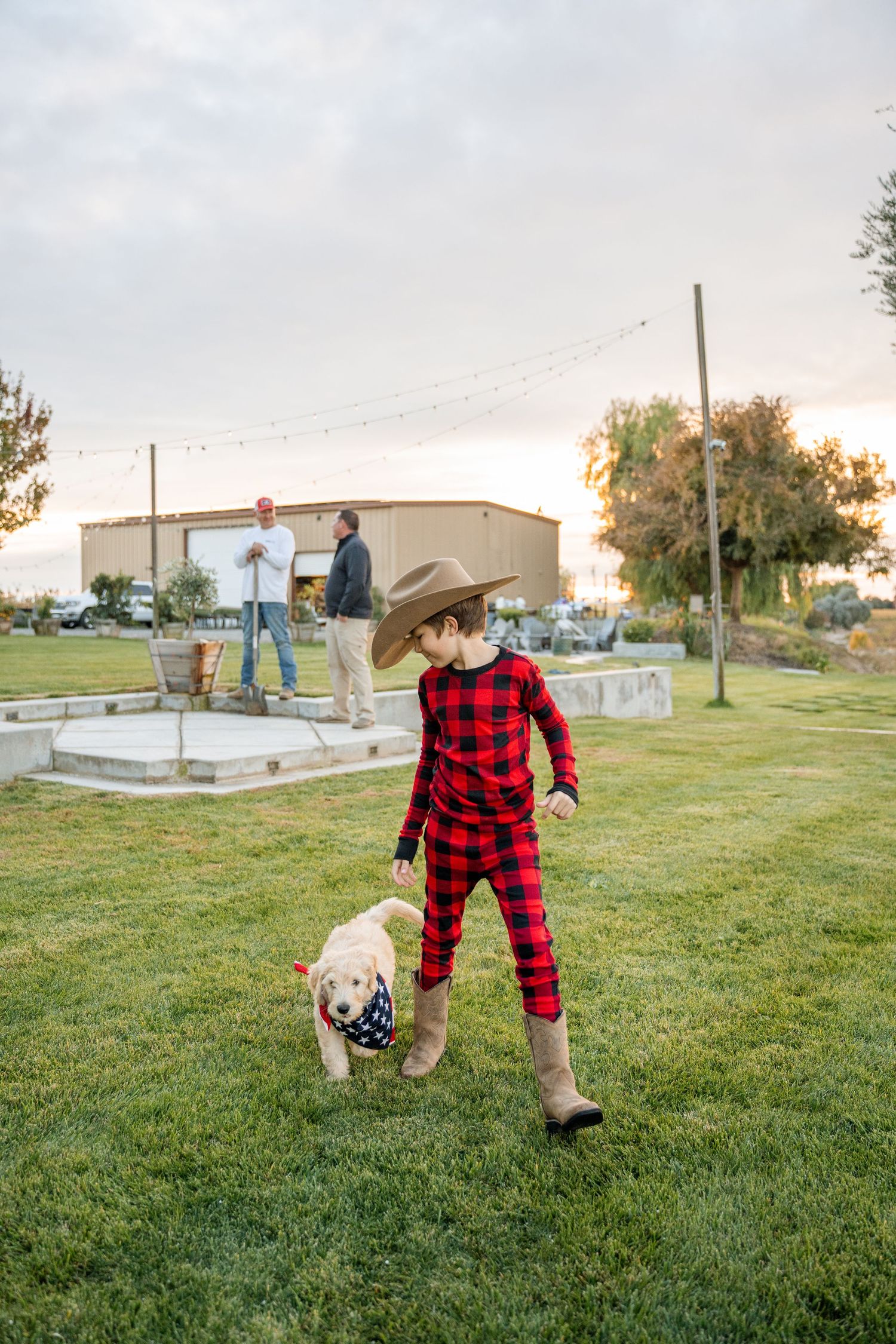 A sequence of playful movements on grass wearing red plaid and cowboy hat.