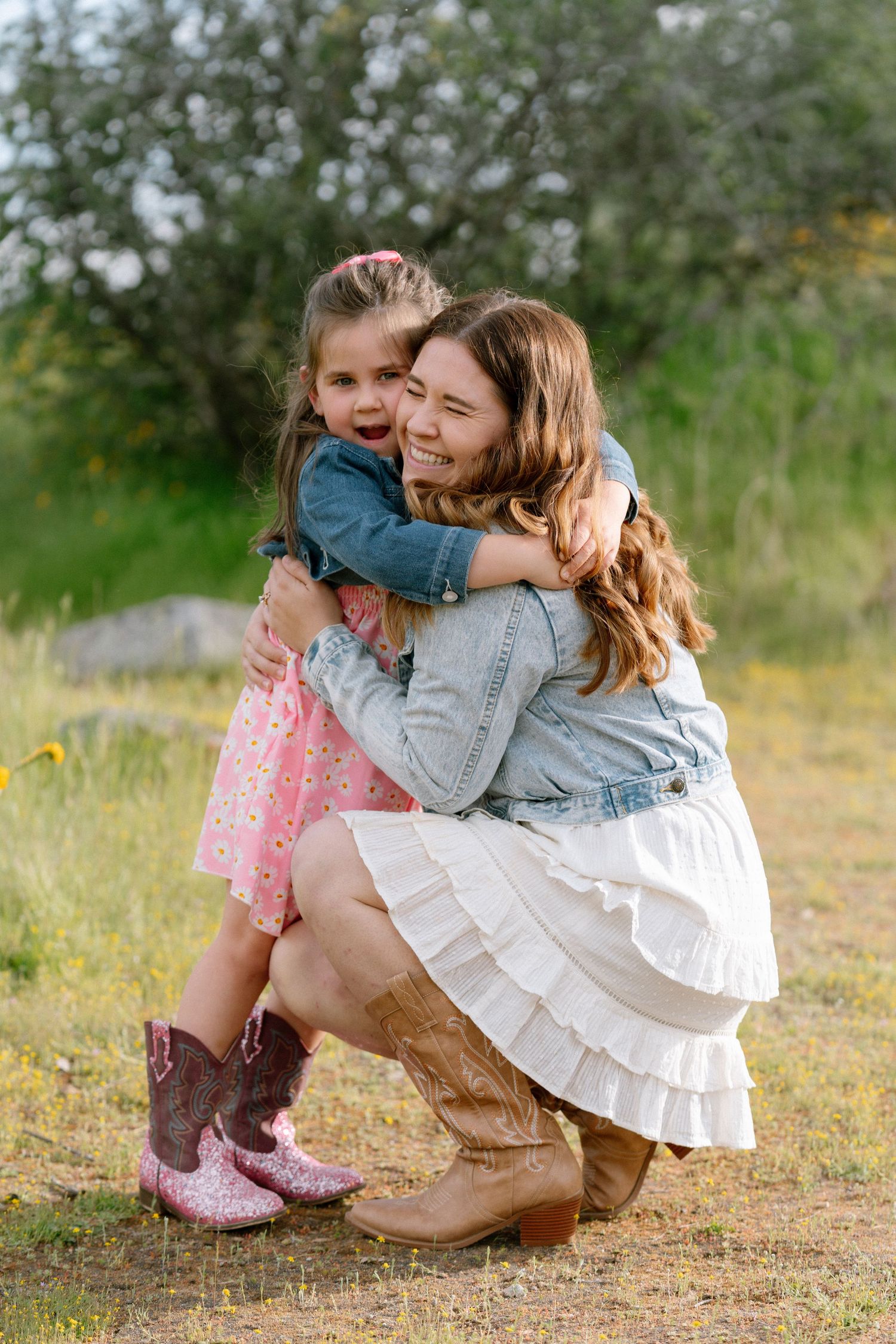 Sweet embraces shared in a sunny meadow during an outdoor photo session.