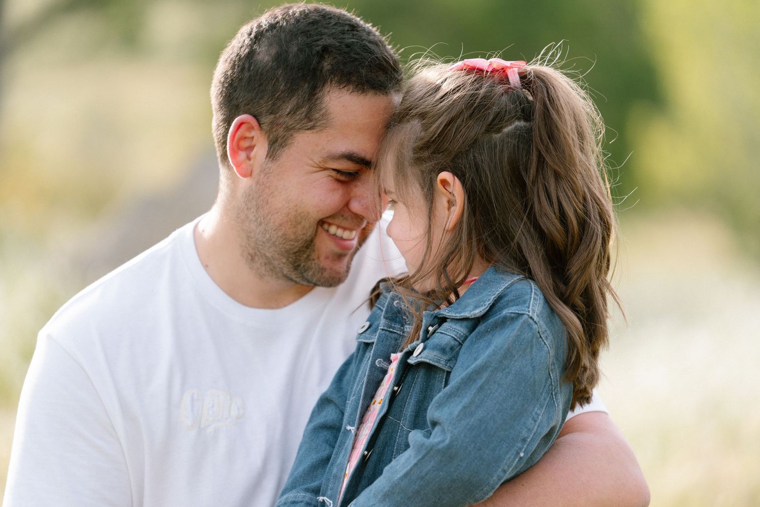 Intimate family moments captured in warm evening light outdoors.