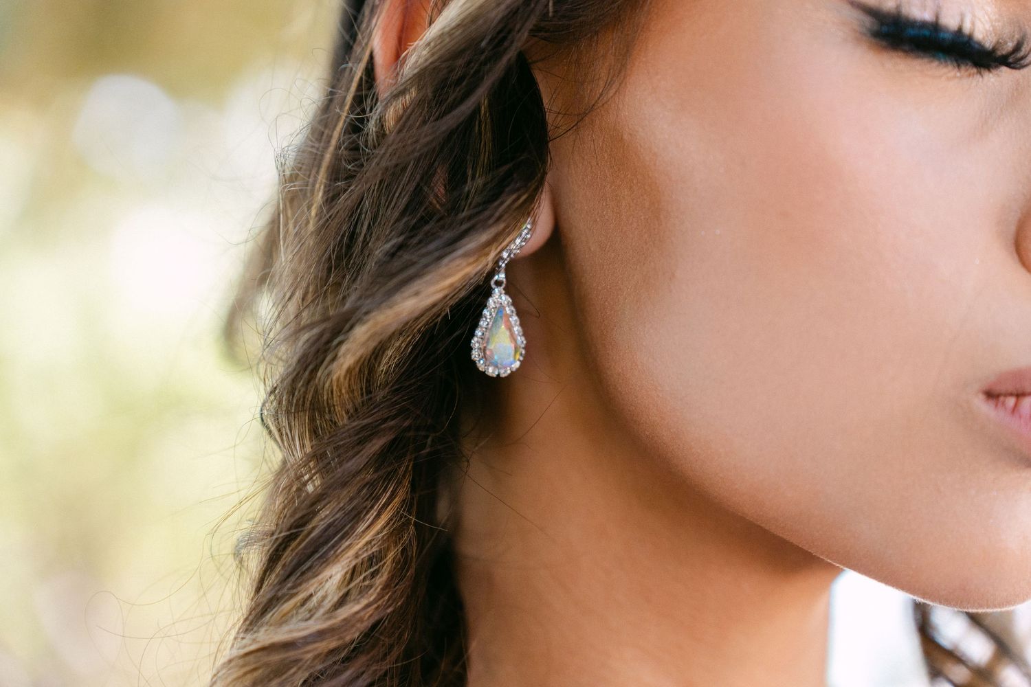 Close-up details of makeup, jewelry and styling for a special occasion.