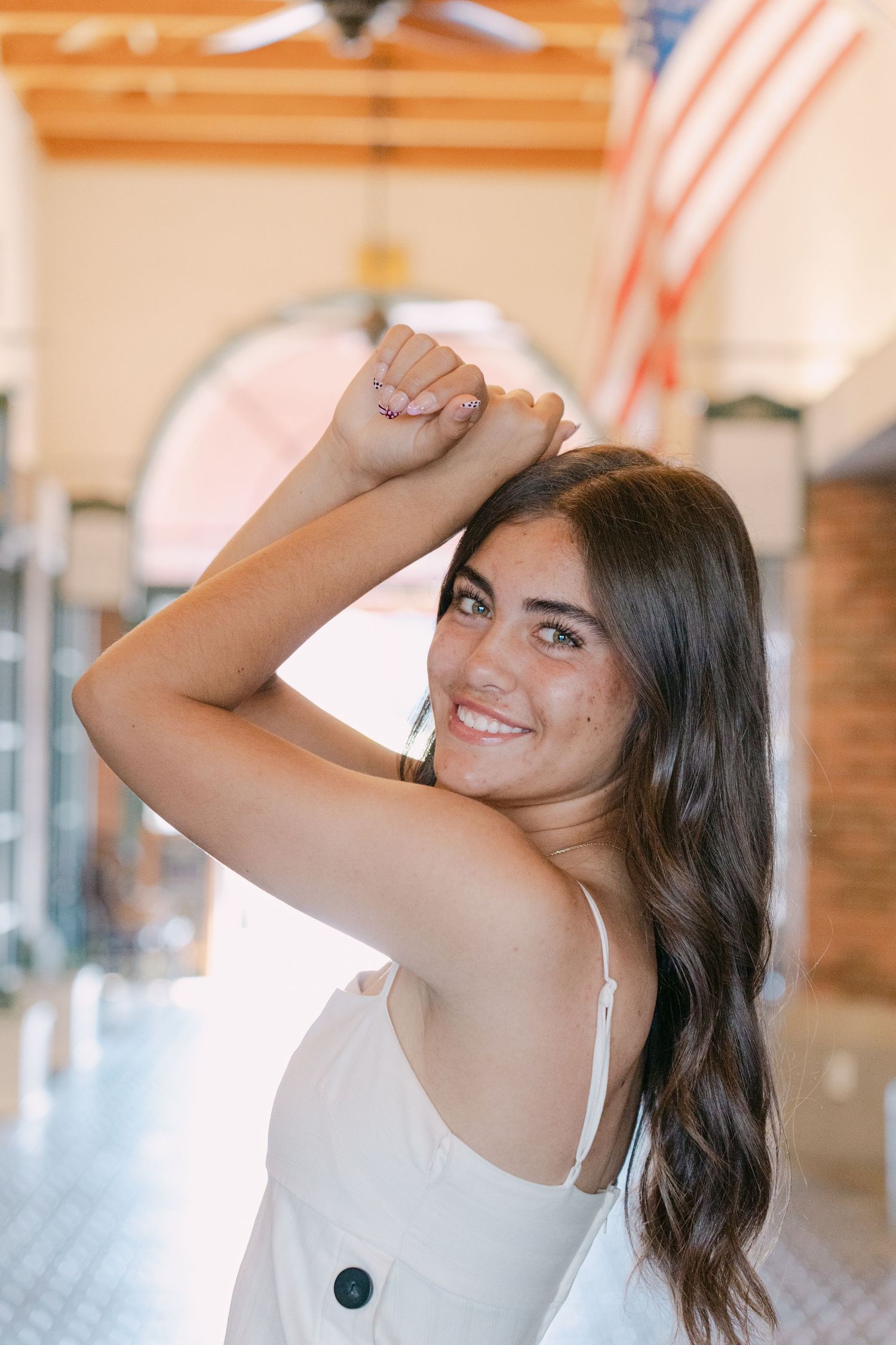 Multiple shots of someone in a white tank top striking casual poses against a warm-toned interior background.