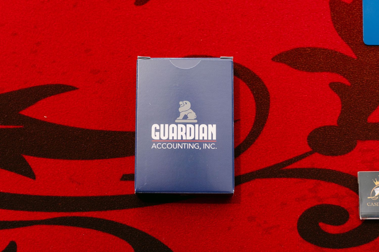 Guardian Accounting logo branded USB drive on red textured background.